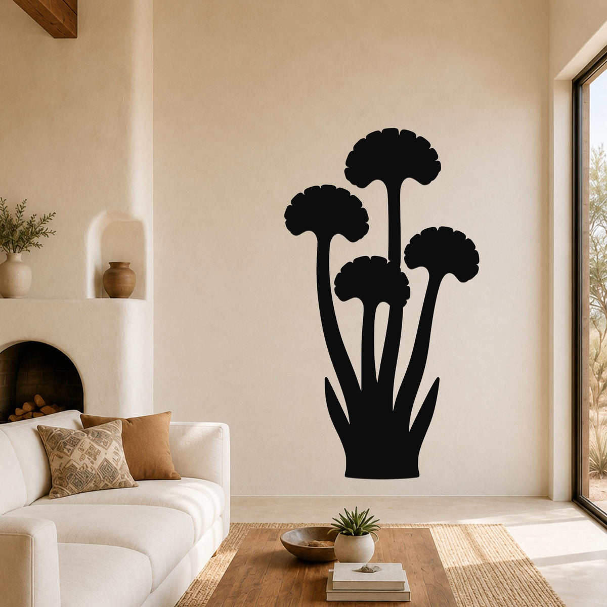 Black metal ginkgo leaf wall art with a silhouette design, mounted on a living room wall above a sofa.