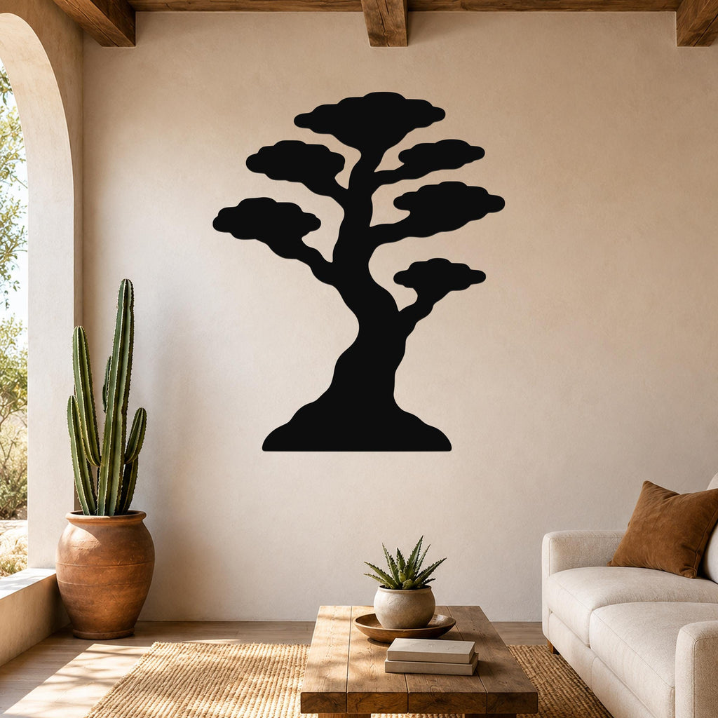 Black metal bonsai tree wall art silhouette mounted on a beige living room wall above a wooden coffee table.