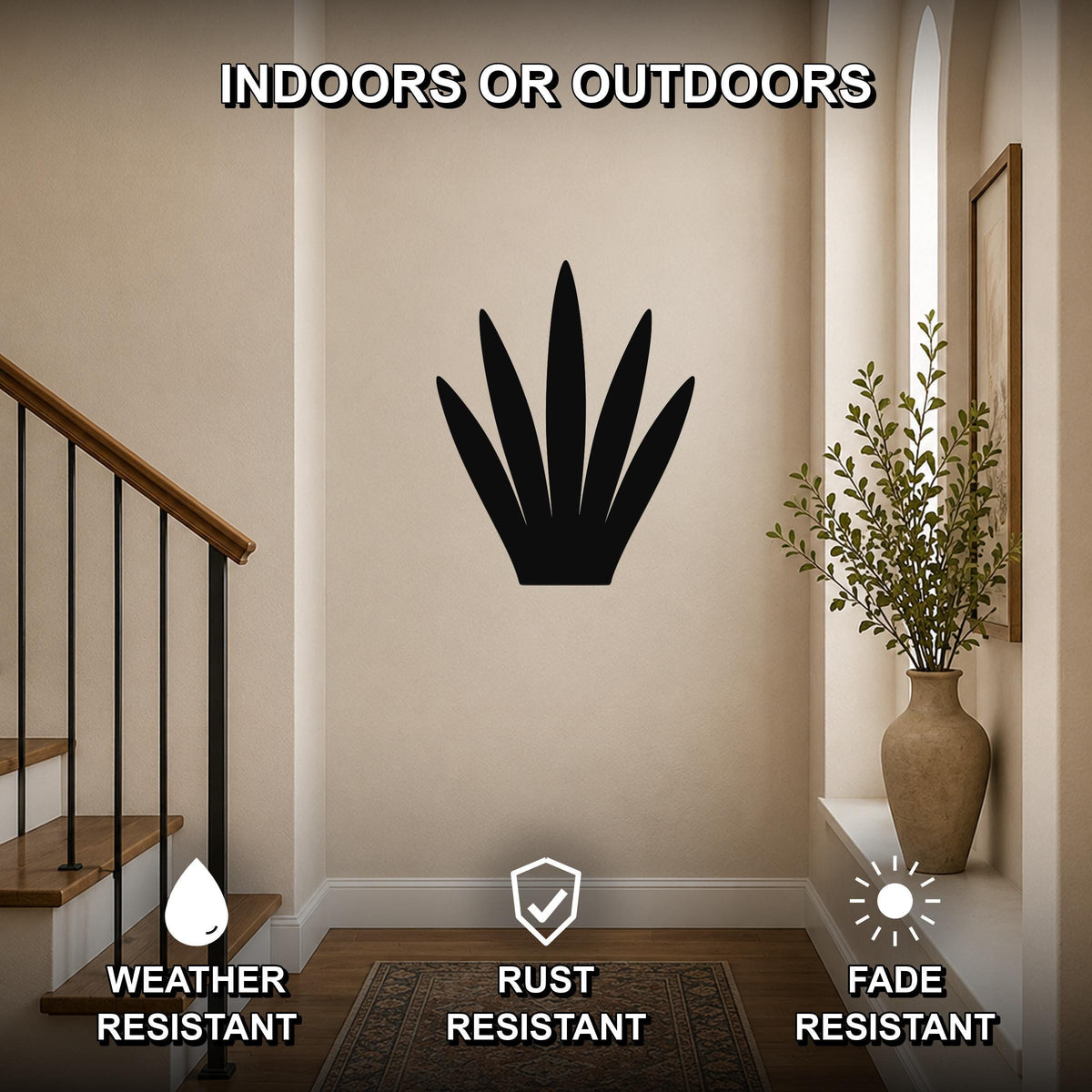 Black metal century plant wall art with spiky leaf cutouts, mounted on a beige hallway wall near a staircase and vase, labeled as weather, rust, and fade resistant for indoor or outdoor use.