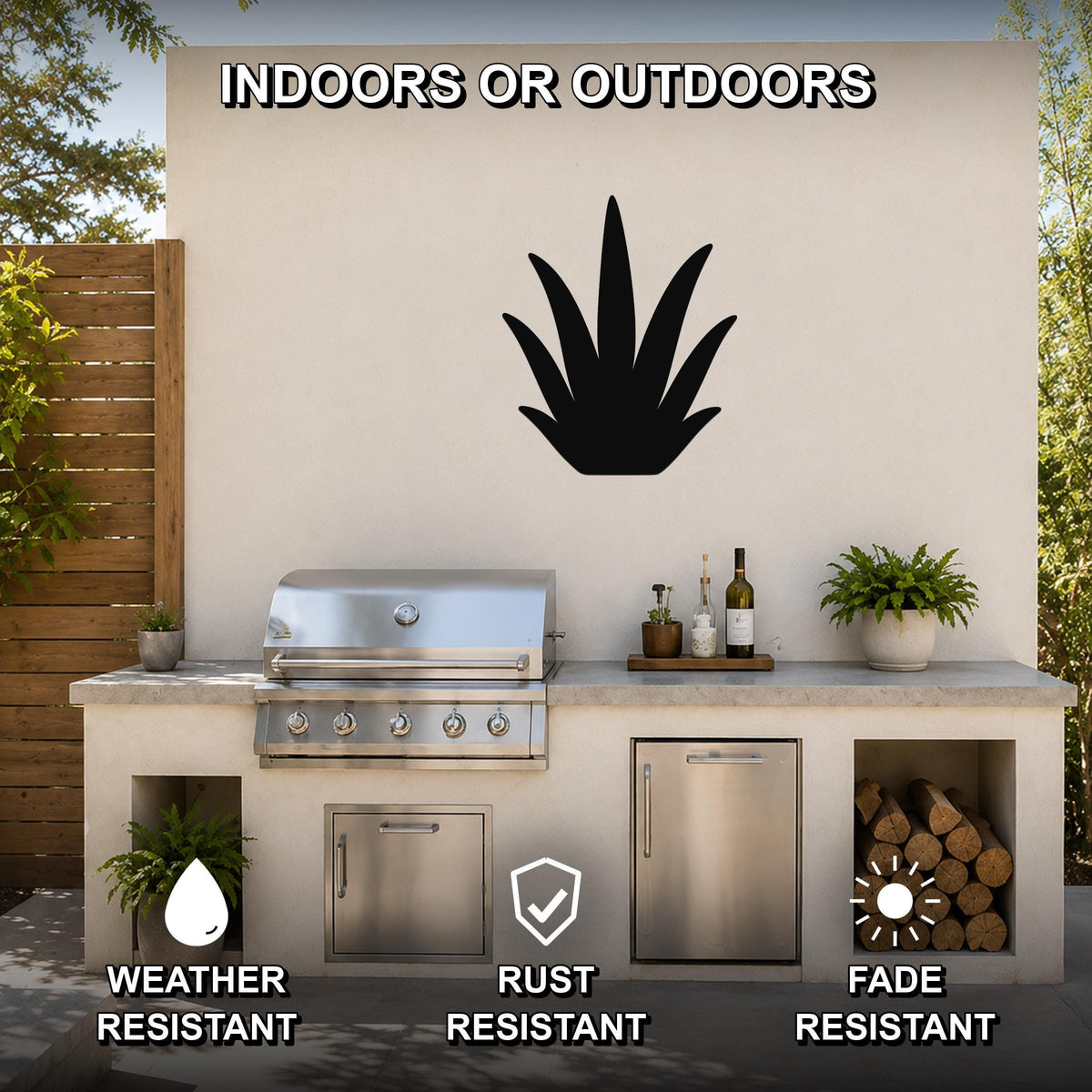 Black metal agave wall art silhouette mounted on an outdoor patio wall above a stainless steel grill and counter.