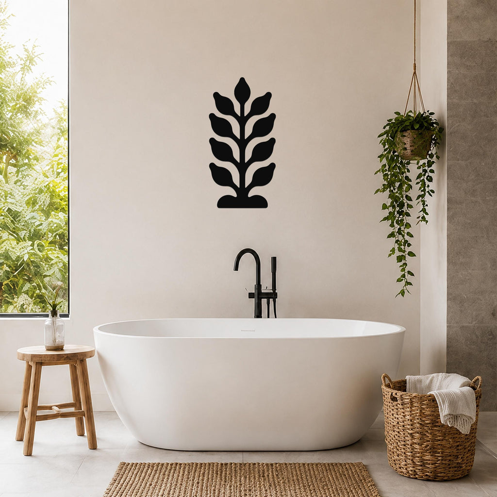Black metal wall art with a leafy plant silhouette, mounted on a bathroom wall above a freestanding tub.