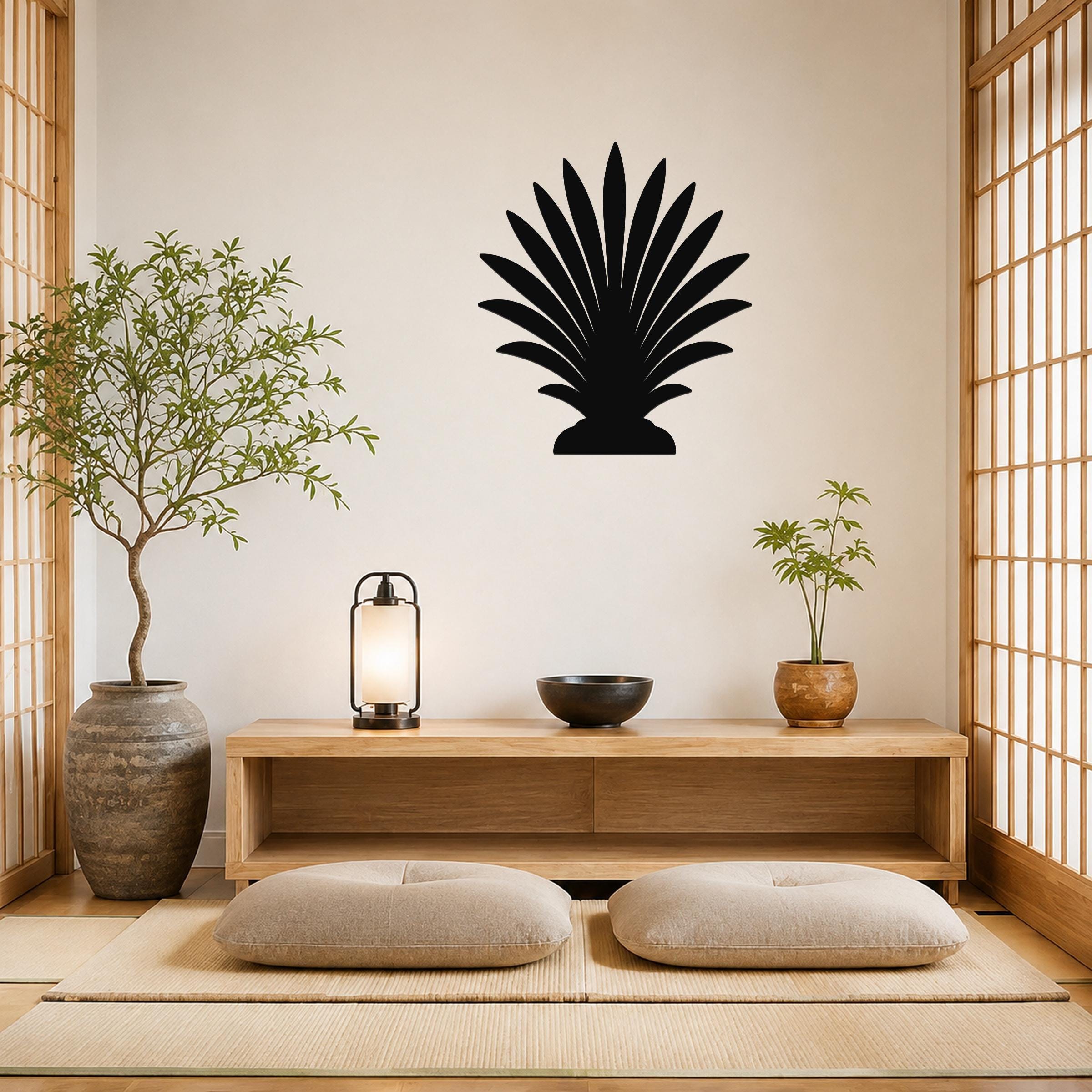 Black metal palm tree wall art with fan-shaped fronds, mounted on a wall above a wooden console in a minimalist living room.