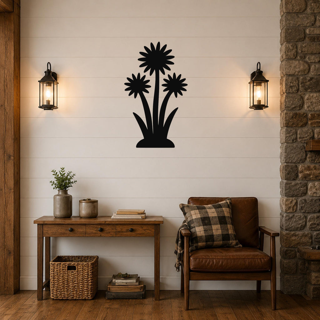 Black metal wall art featuring a silhouette of three wildflowers with layered petals and long stems, mounted on a shiplap wall above a wooden console table in a living room.
