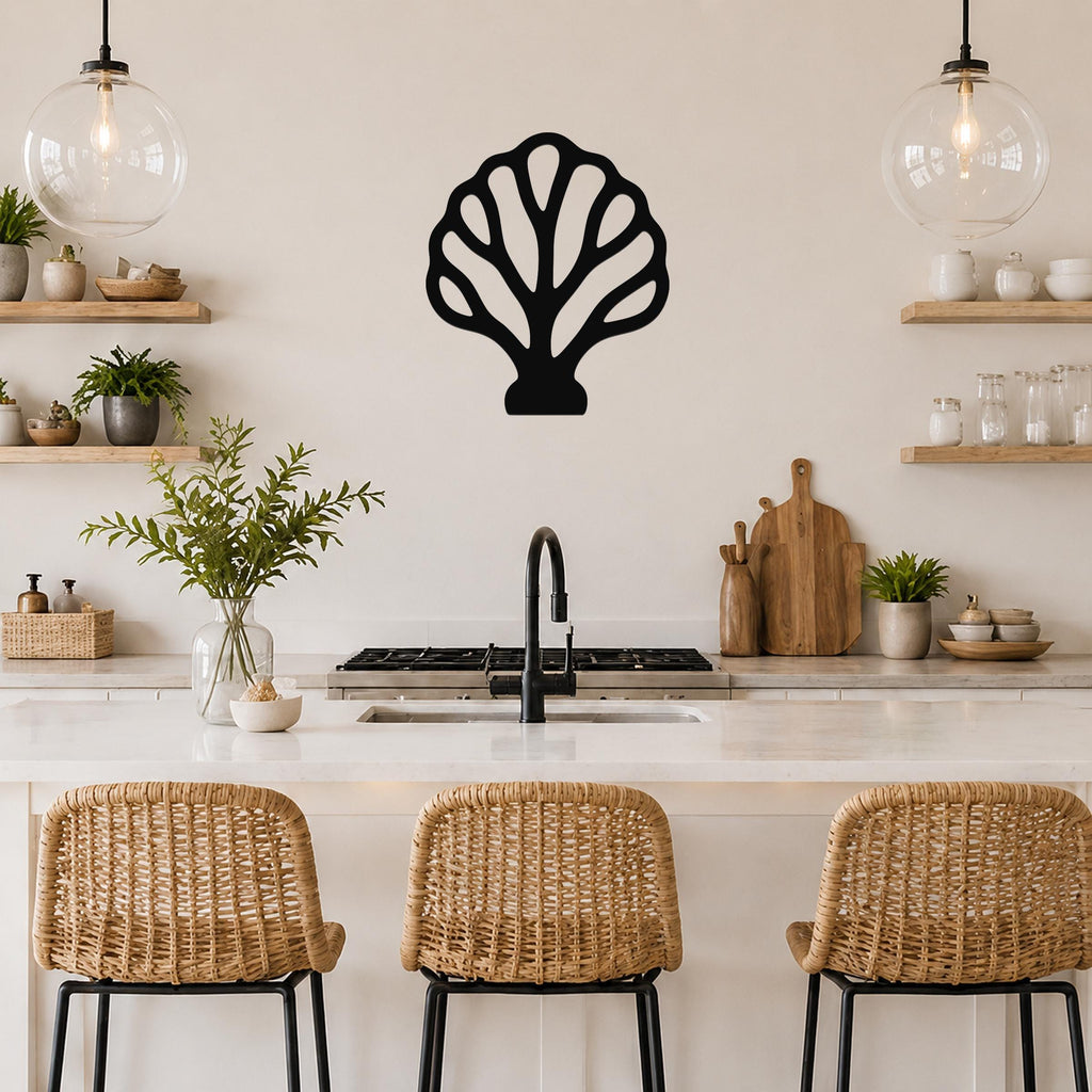 Black metal fan coral wall art with intricate cutout details, mounted on a kitchen wall above a counter.