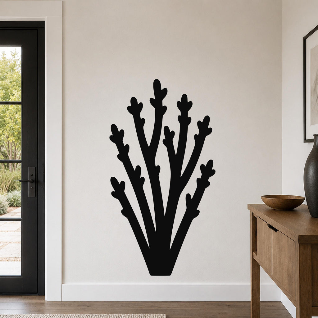 Black metal wall art in a branching silhouette design, mounted on a light-colored wall in a modern entryway.
