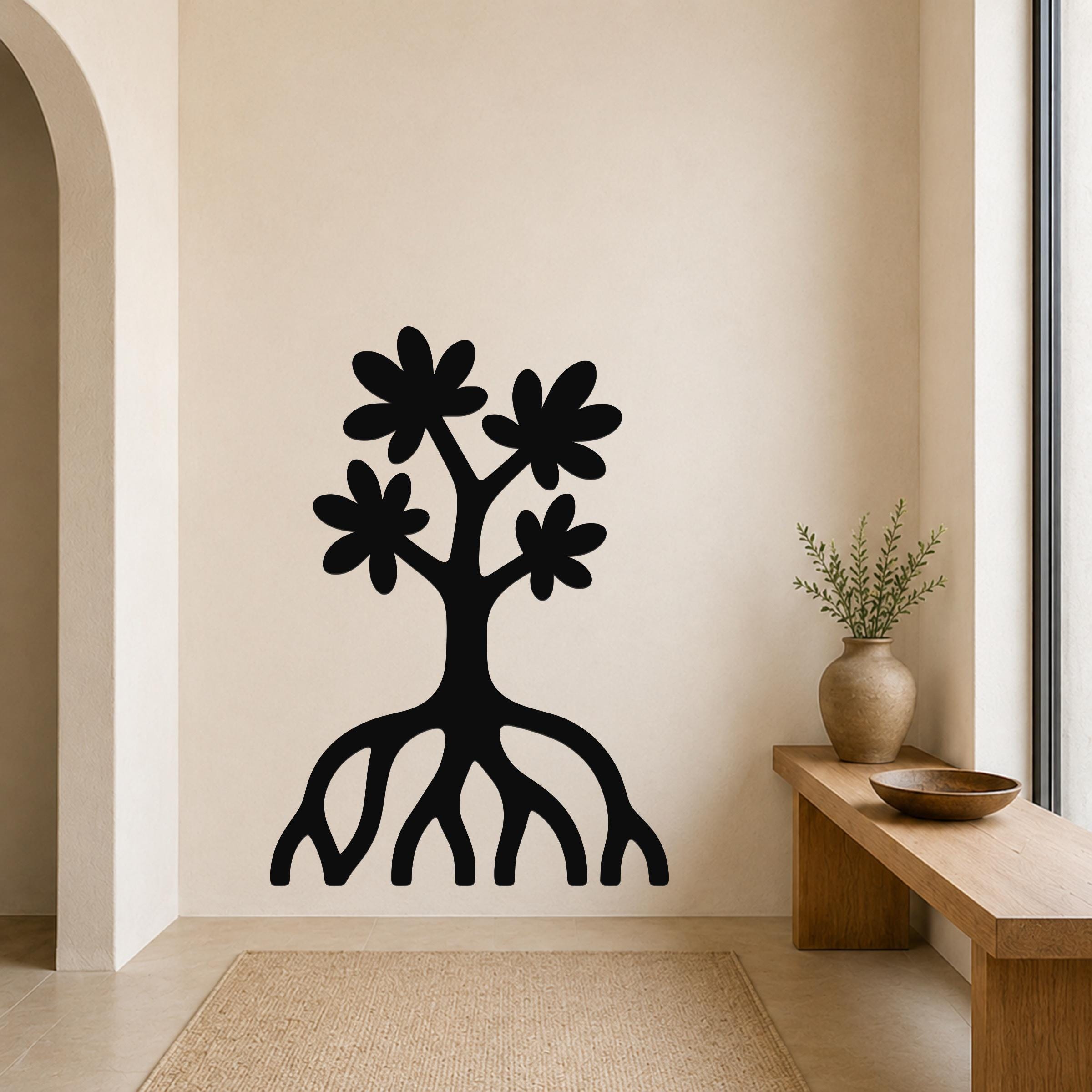 Black metal wall art in a tree silhouette with blossoms and visible roots, mounted on a beige wall above a wooden bench in a minimalist entryway.