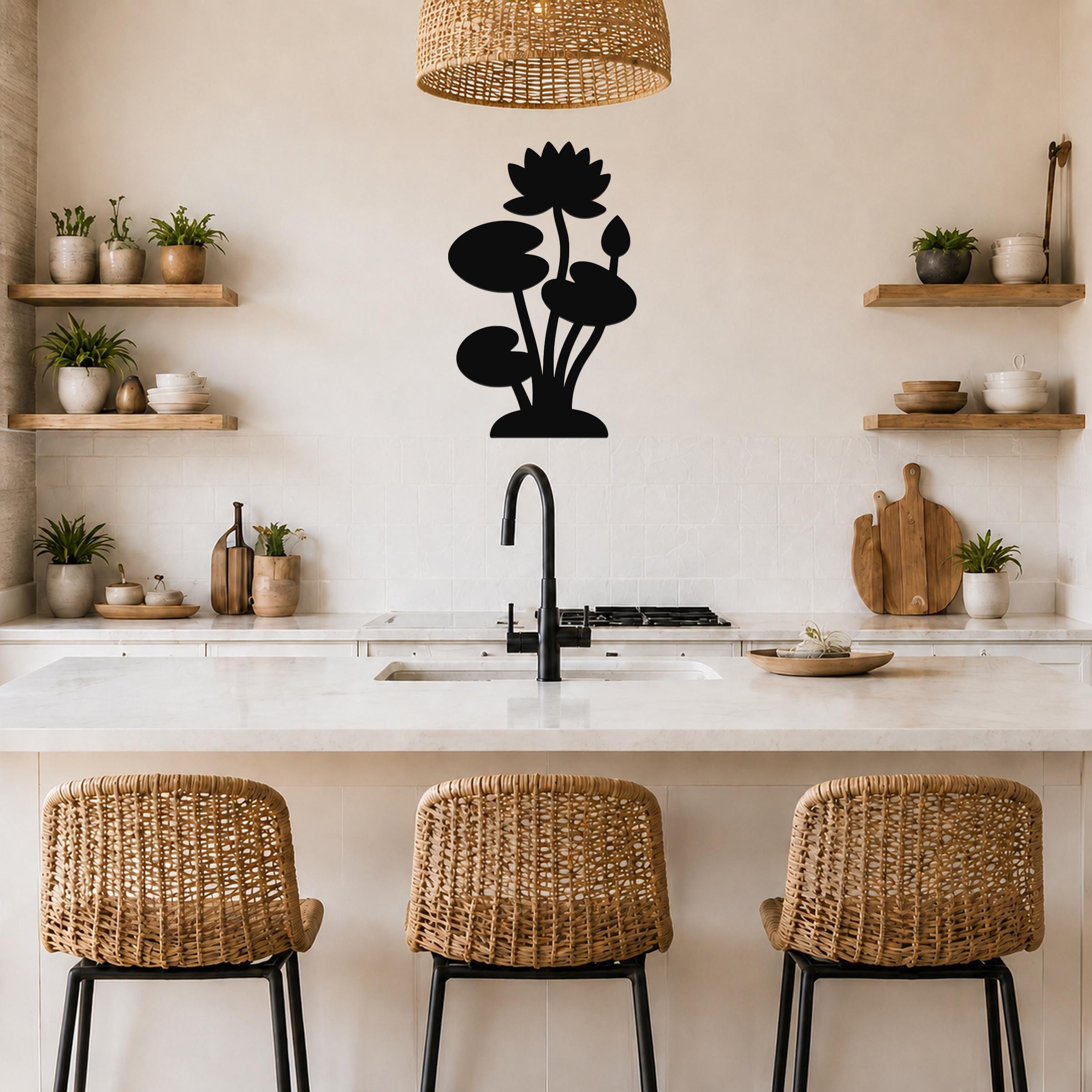 Black metal lotus water lily wall art with flower and leaf cutouts, mounted on a kitchen wall above a counter.