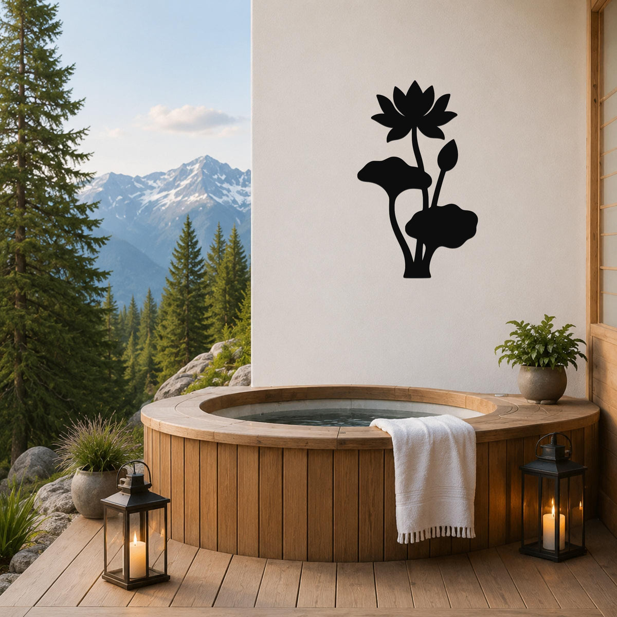 Black metal lotus flower wall art with leaf and bud cutouts, mounted on a white wall above a wooden hot tub on a mountain-view deck.