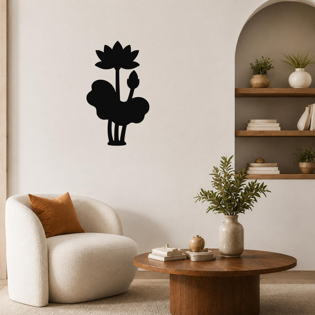 Black metal lotus wall art with a silhouette of a blooming flower and leaves, mounted on a living room wall above a round wooden coffee table.