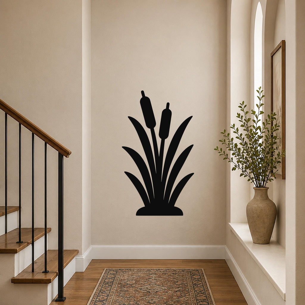 Black metal cattail wall art silhouette with two seed heads, mounted on a hallway wall above a patterned rug near a staircase.