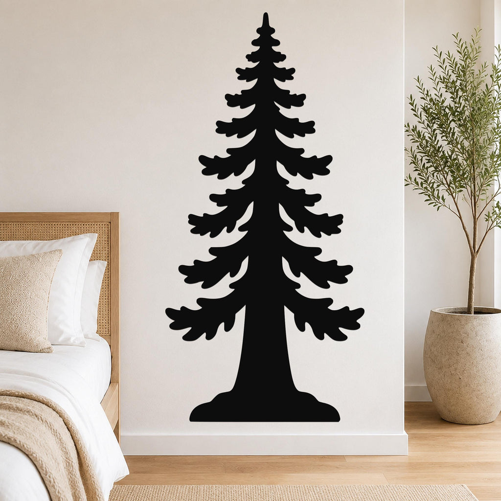 Black metal wall art of a sequoia tree silhouette, mounted on a bedroom wall above a bed with a woven headboard.