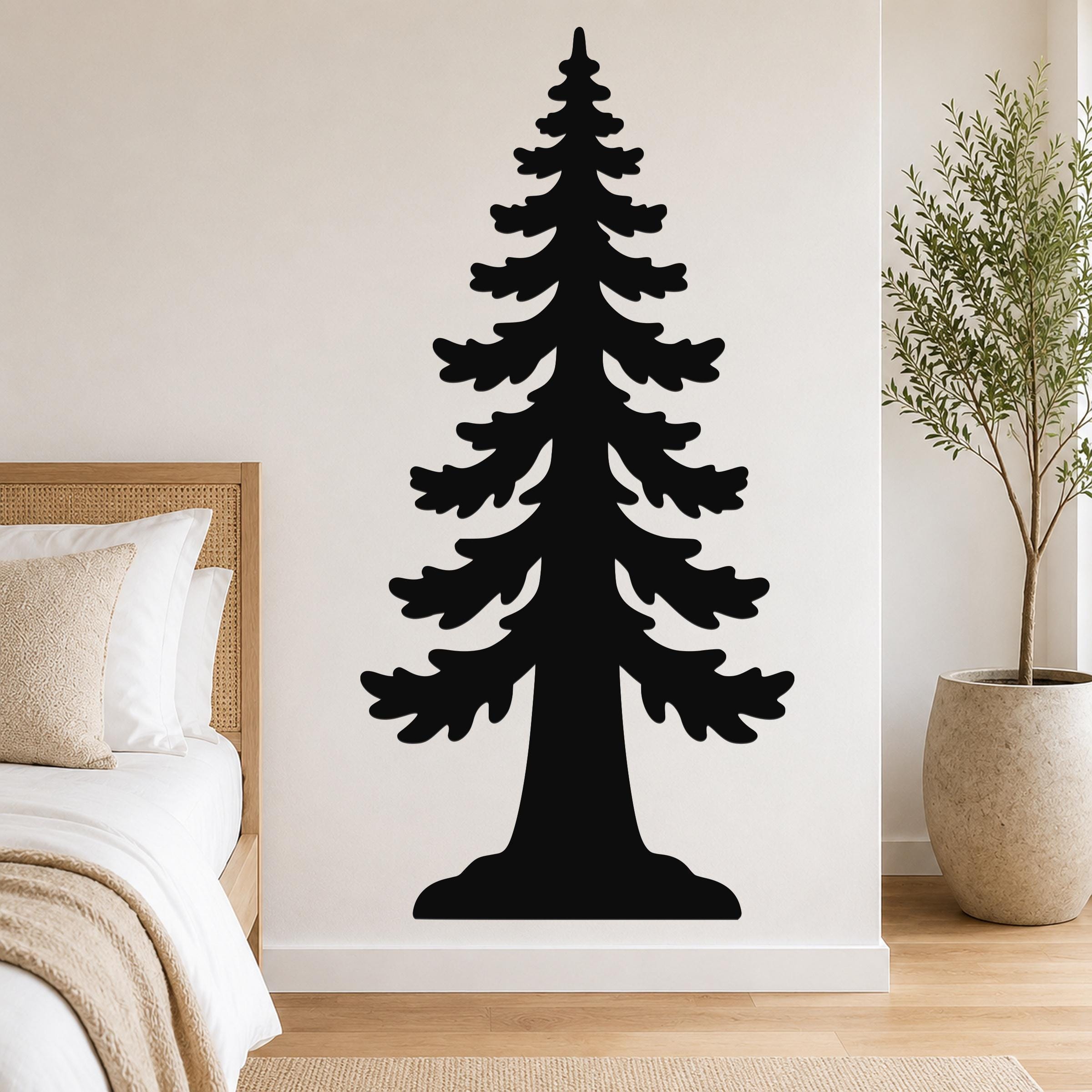 Black metal wall art of a sequoia tree silhouette, mounted on a bedroom wall above a bed with a woven headboard.