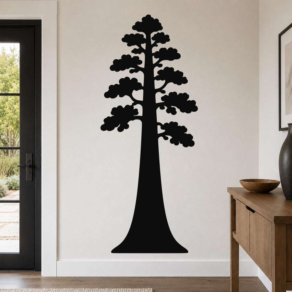 Black metal sequoia tree wall art with layered branch cutouts, mounted on a living room wall above a wooden console table.