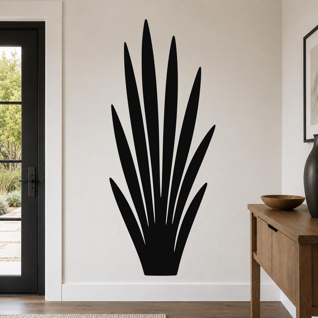Black metal wall art in a tall, spiky grass silhouette, mounted on a living room wall above a wooden console table.
