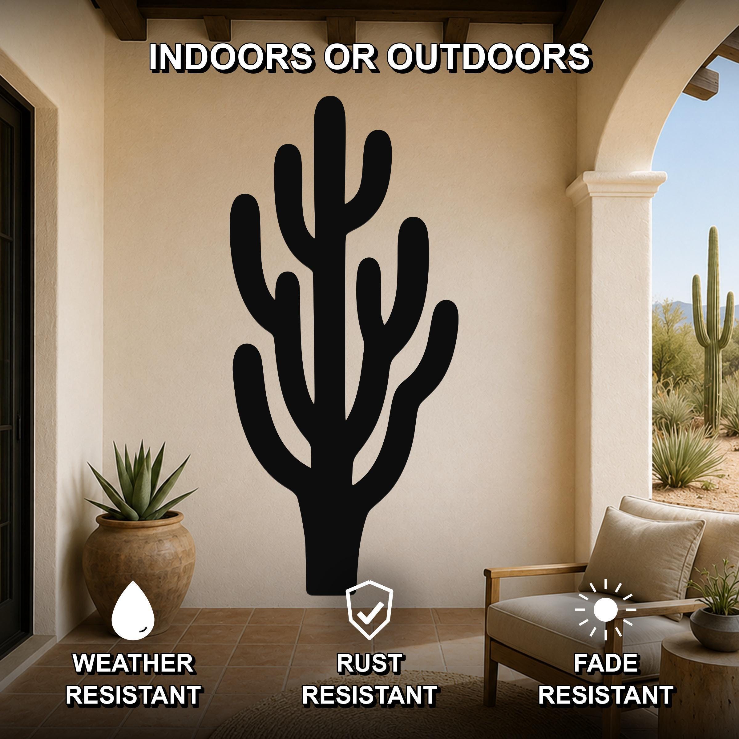 Black metal saguaro cactus wall art with branching cutouts, mounted on a beige patio wall above a wooden chair, weather resistant, rust resistant, and fade resistant.