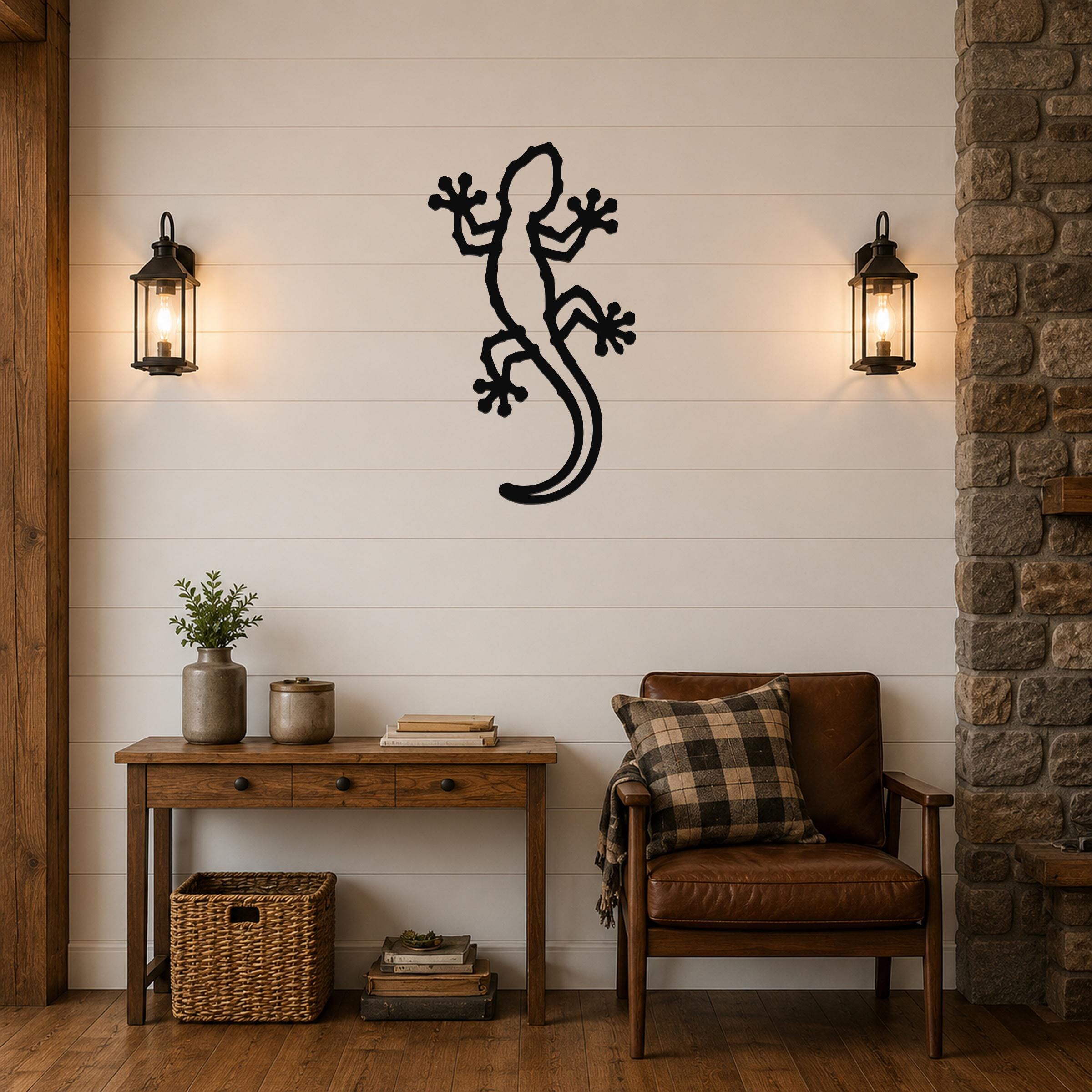 Black metal lizard wall art with detailed cutout legs and tail, mounted on a shiplap wall above a wooden console table in a living room.