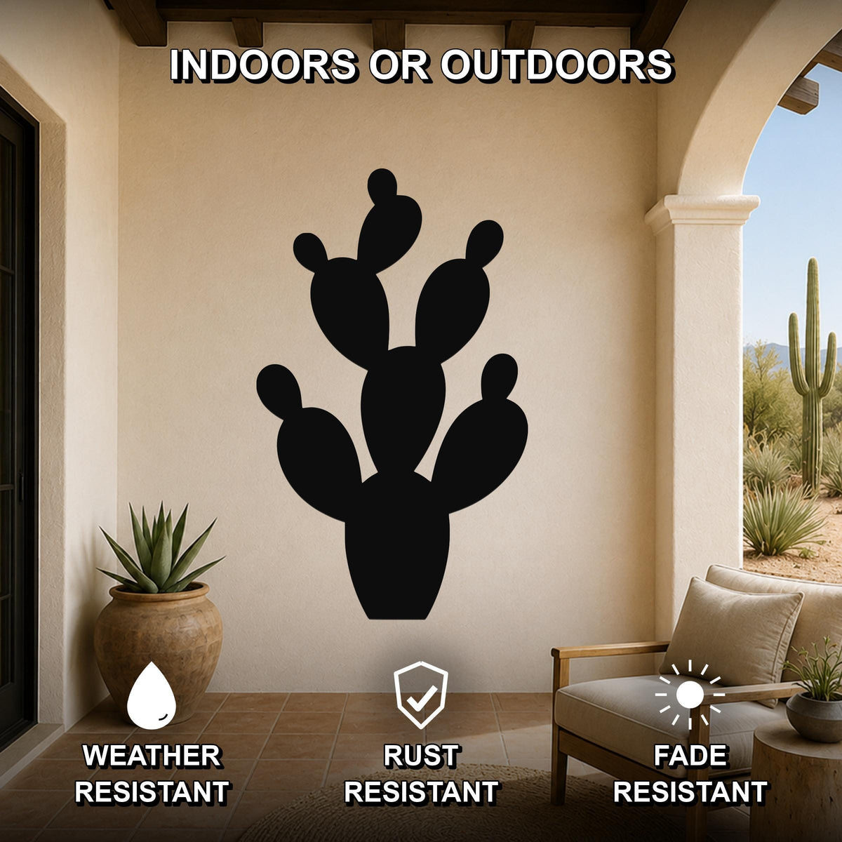 Black metal prickly pear cactus wall art with cutout branches, mounted on a beige outdoor patio wall above a wooden chair.