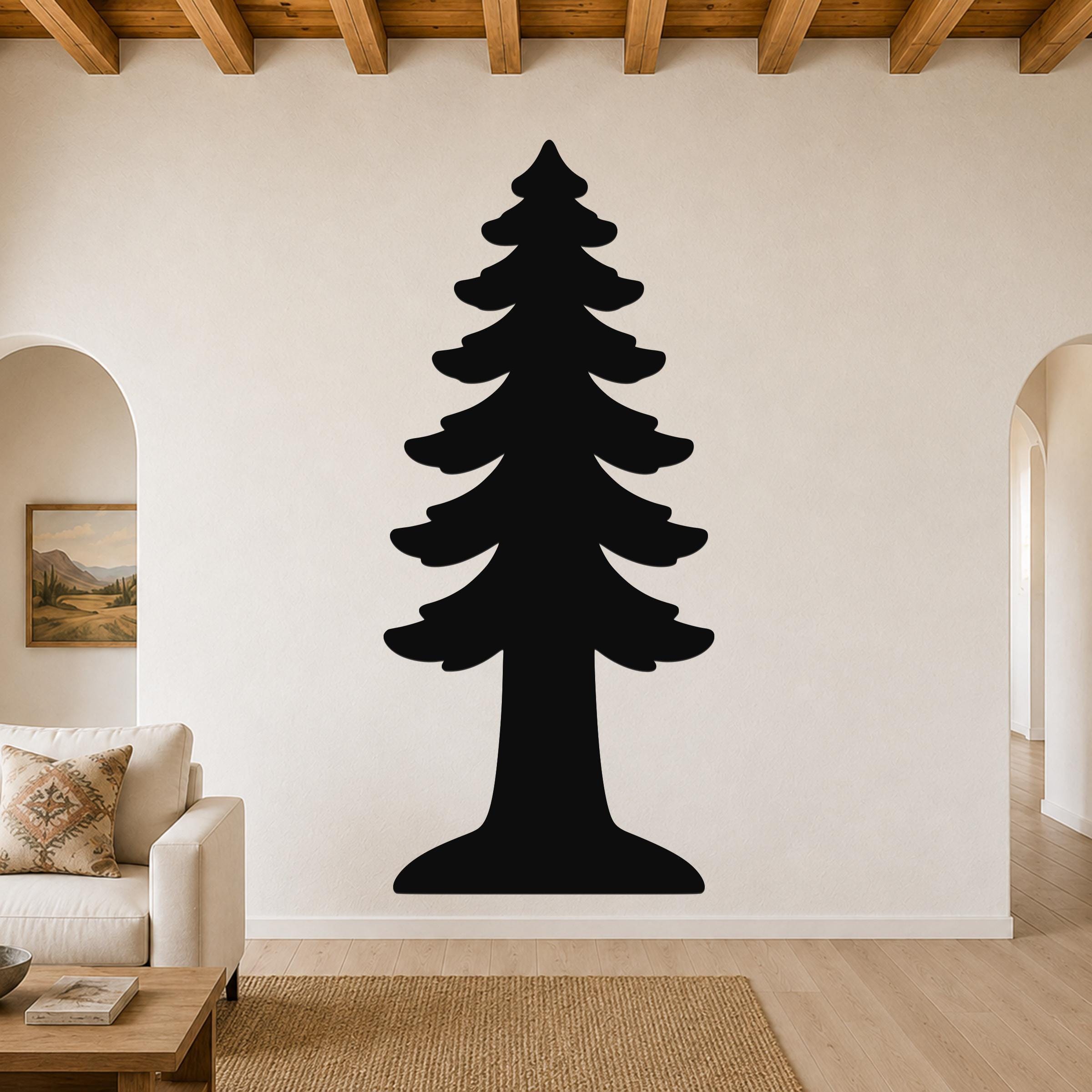Black metal wall art in the silhouette of a tall redwood tree, mounted on a living room wall above a beige sofa.