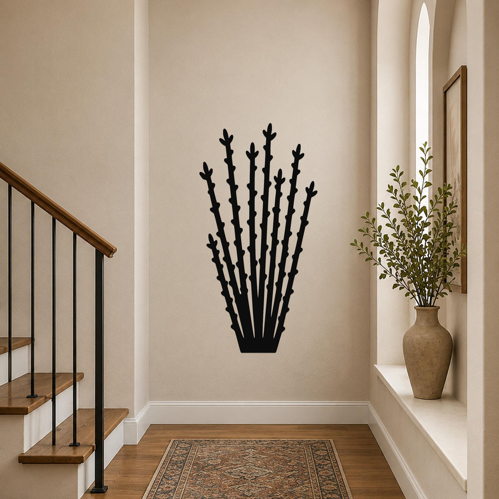 Black metal ocotillo wall art with spiky branch cutouts, mounted on a hallway wall above a patterned rug.