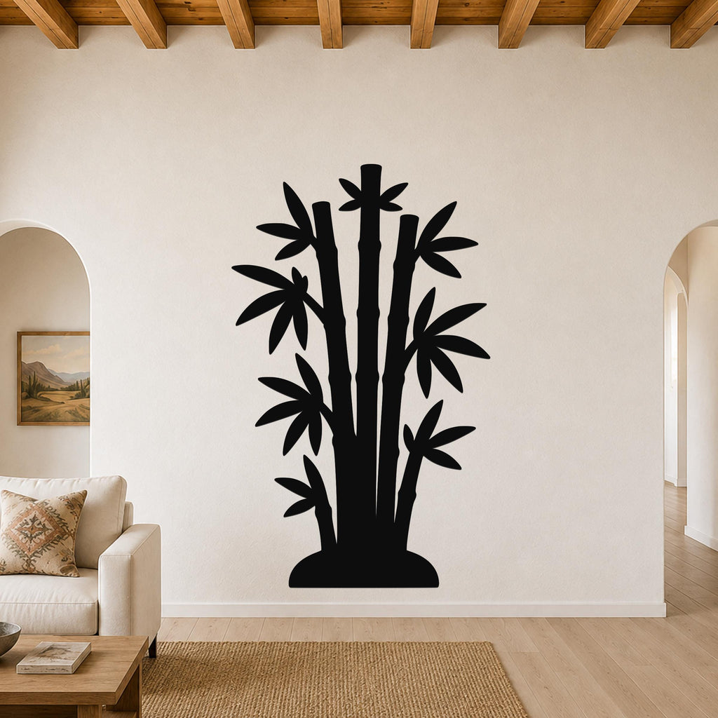 Black metal bamboo wall art silhouette with multiple stalks and leaves, mounted on a living room wall above a sofa.