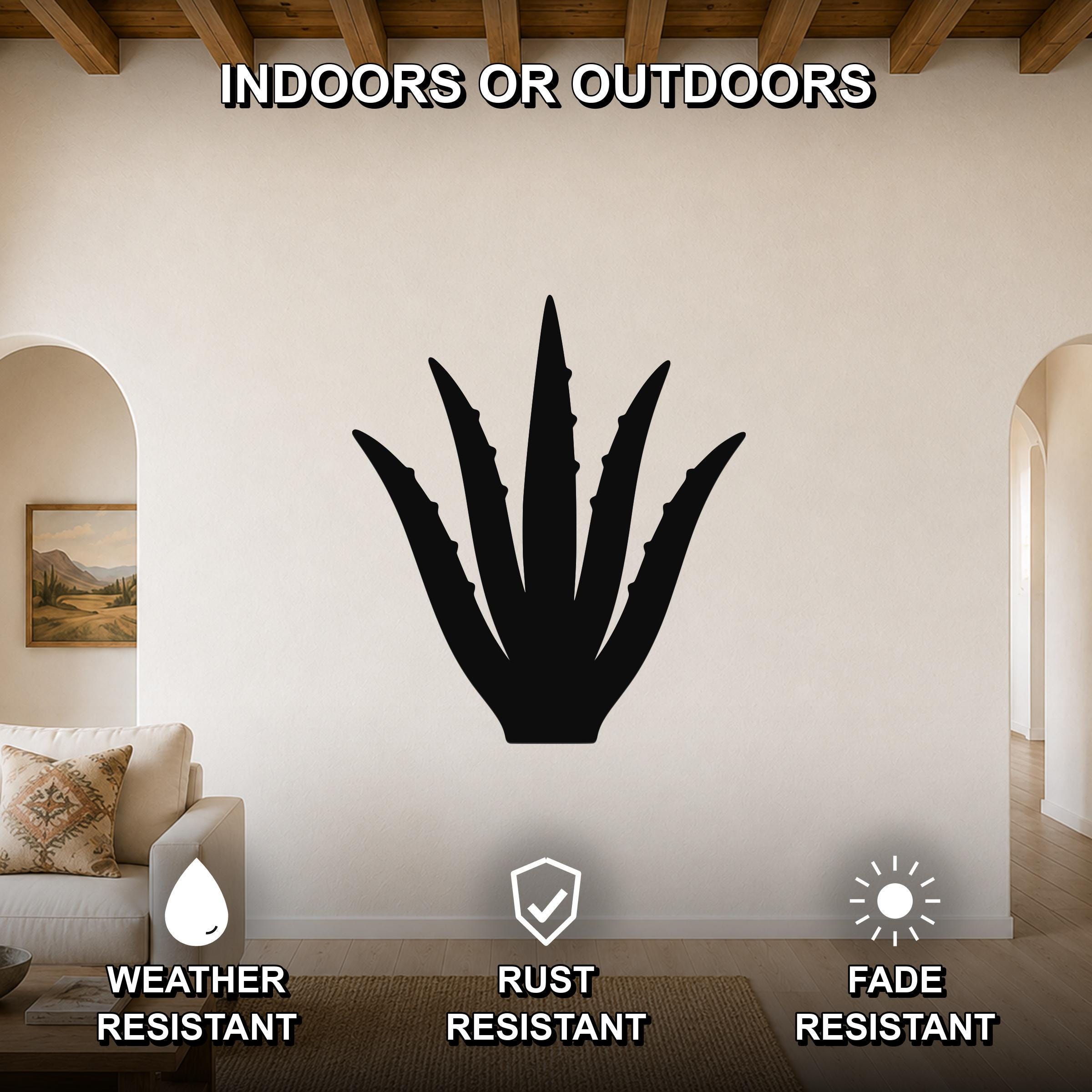 Black metal agave wall art silhouette mounted on a living room wall above a sofa, featuring weather, rust, and fade resistant properties.