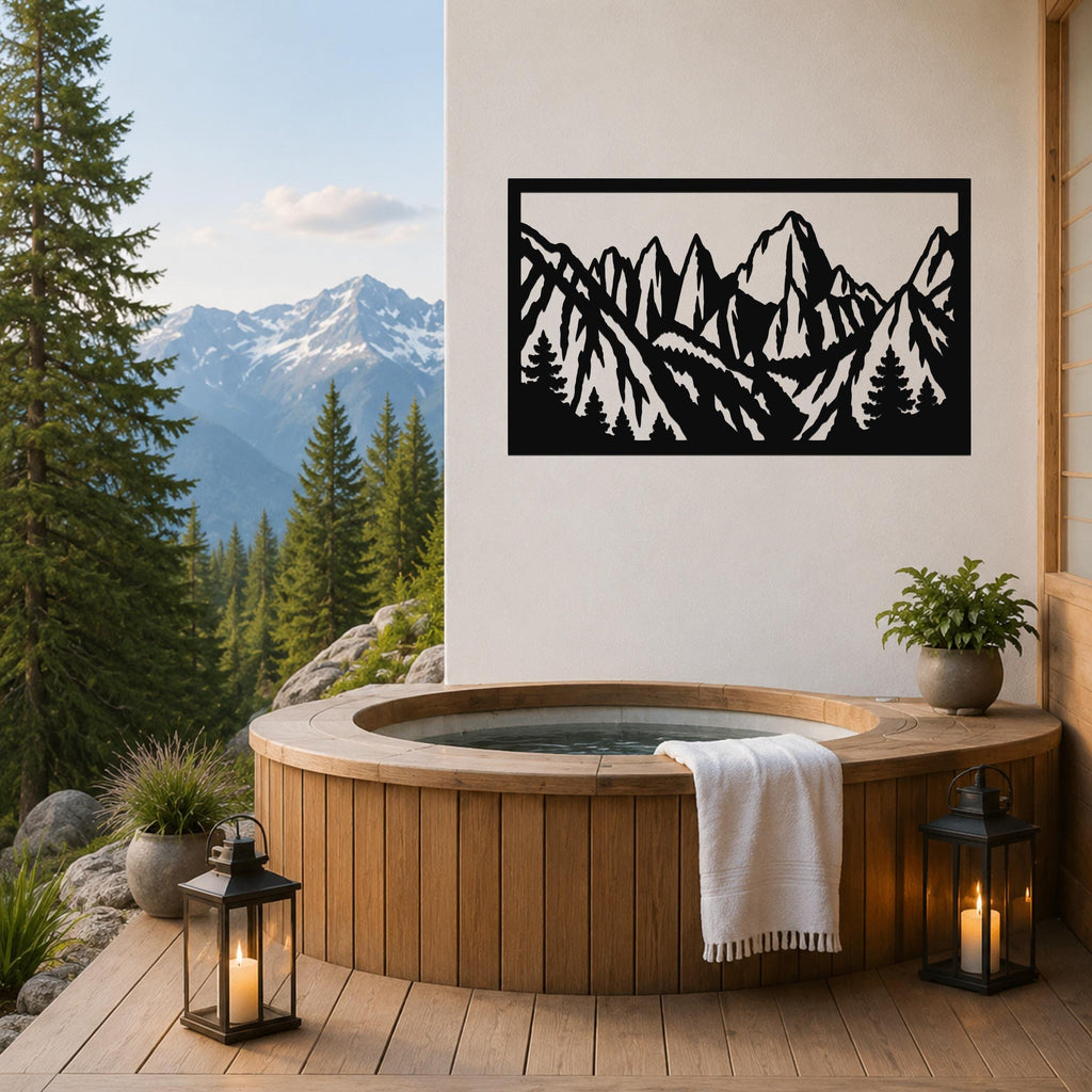 Black metal wall art with a mountain range silhouette, mounted on a white wall above a wooden hot tub on a deck.