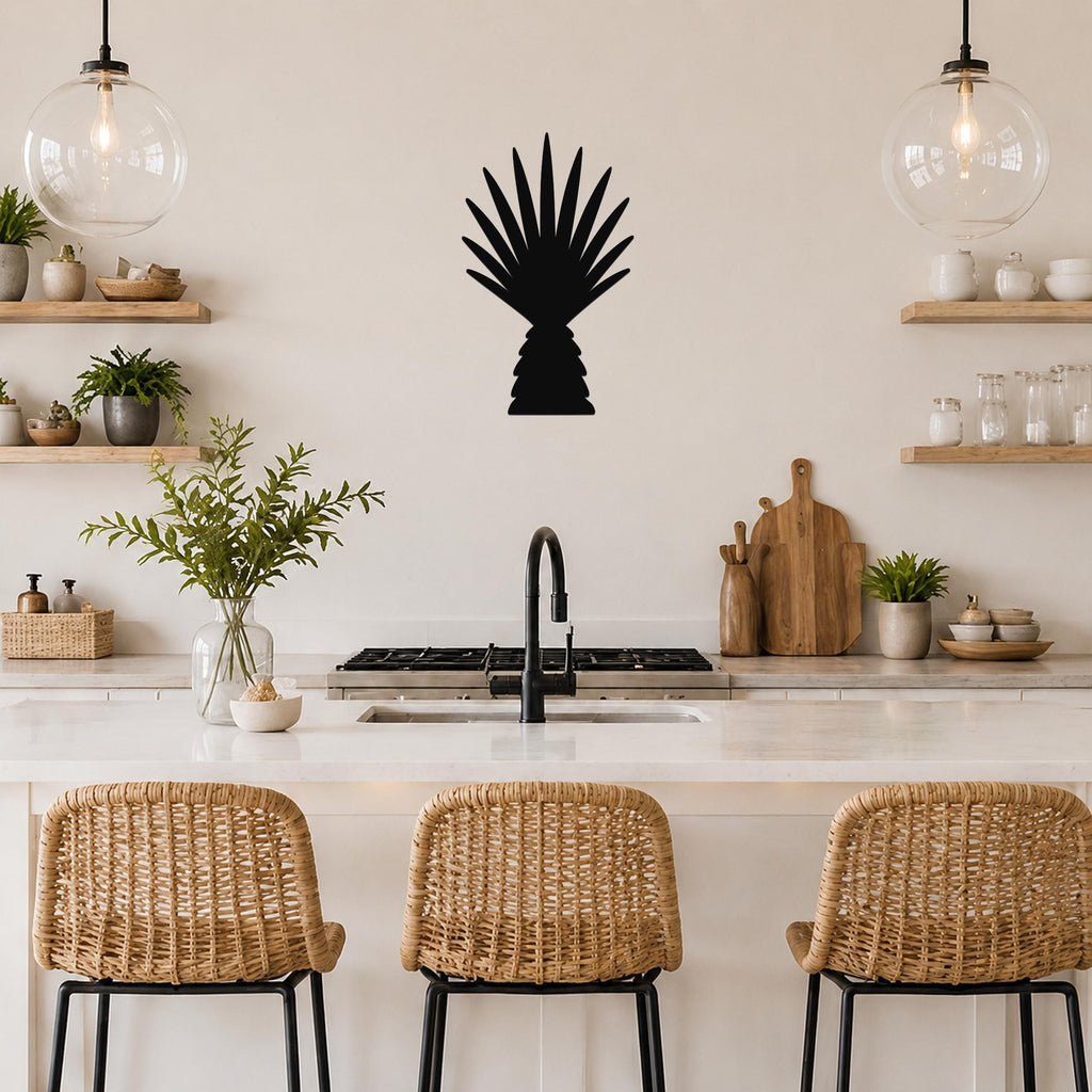 Black metal palm tree wall art with fan-shaped fronds, mounted on a kitchen wall above a counter with wicker bar stools.