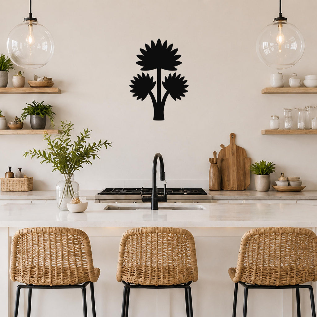 Black metal wall art featuring a fan palm tree silhouette with three flower-like shapes, mounted on a kitchen wall above a counter.