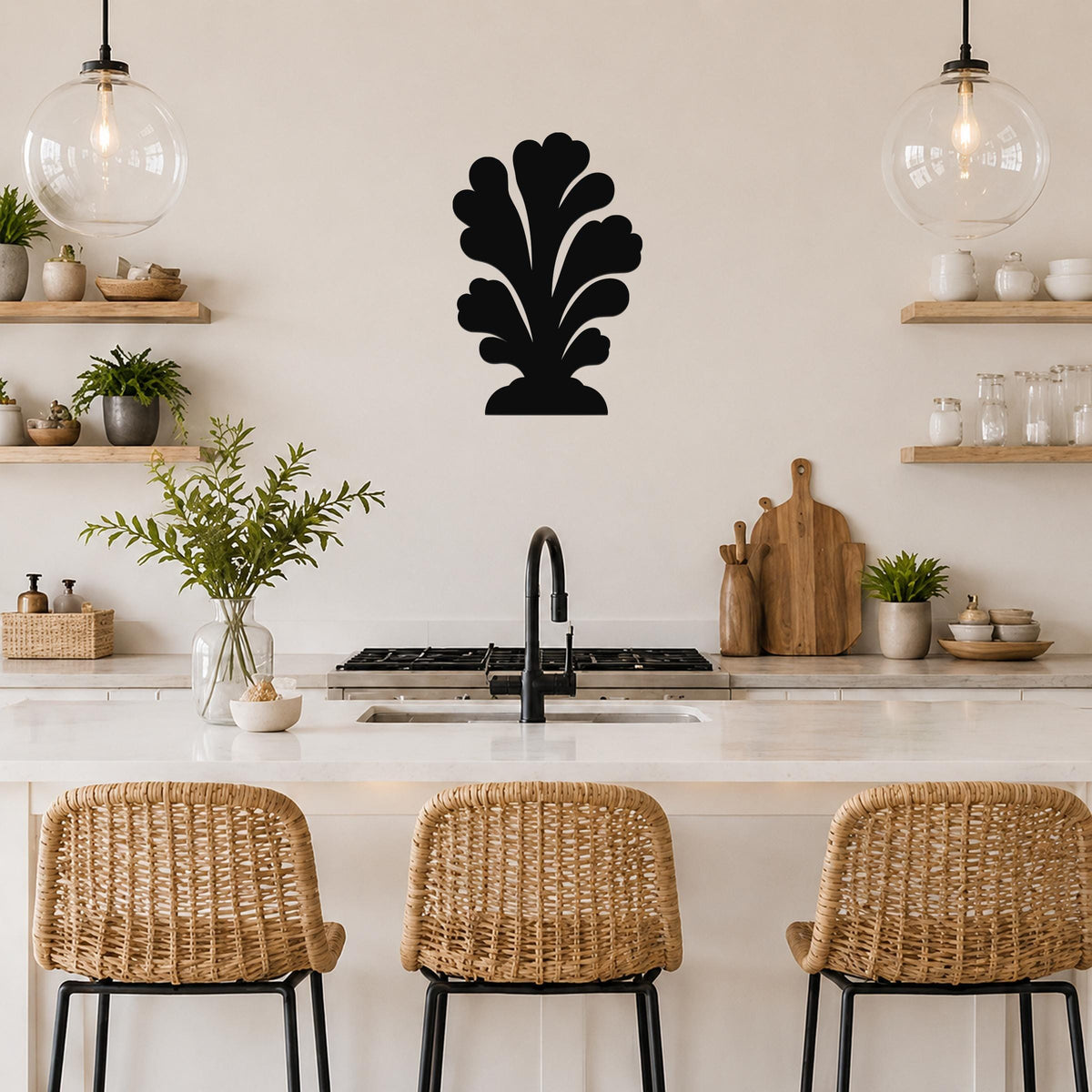 Black metal wall art in a coral or leaf-like silhouette, mounted on a kitchen wall above a counter with wicker bar stools.