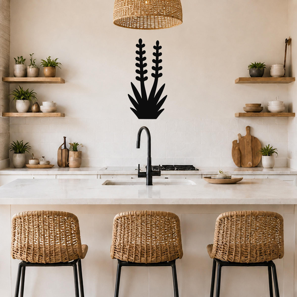 Black metal yucca wall art with leaf and bloom cutouts, mounted on a kitchen wall above a counter.