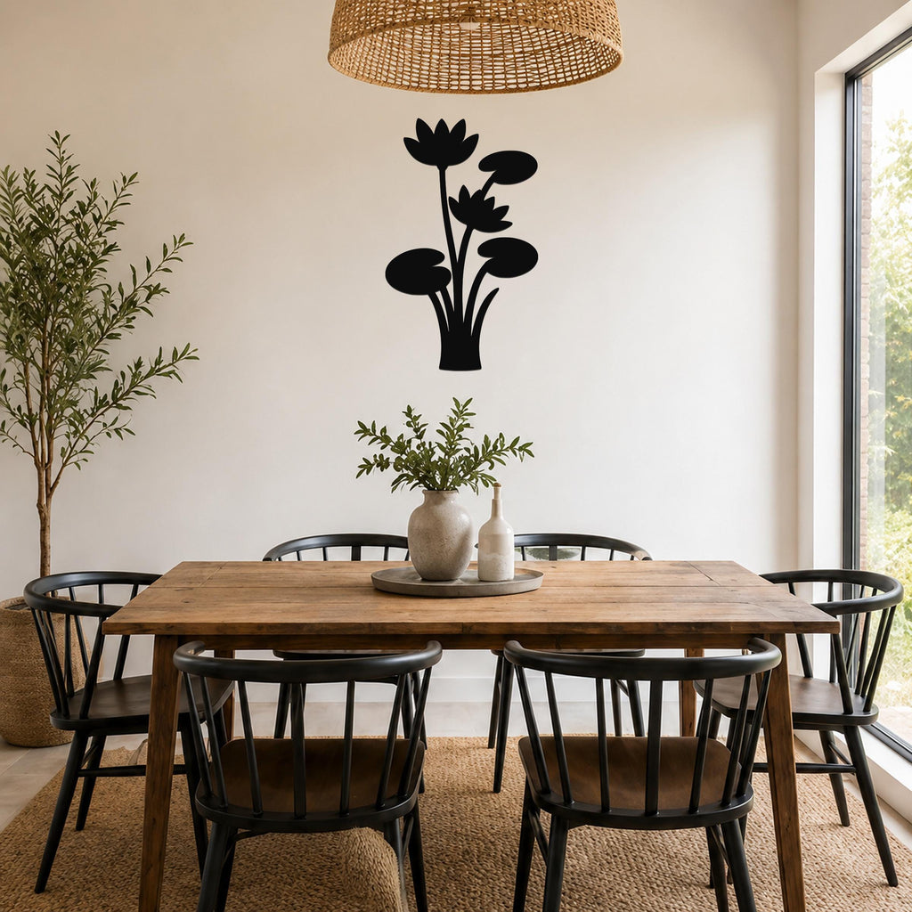 Black metal lotus water lily wall art with layered flower and leaf cutouts, mounted on a dining room wall above a wooden table.