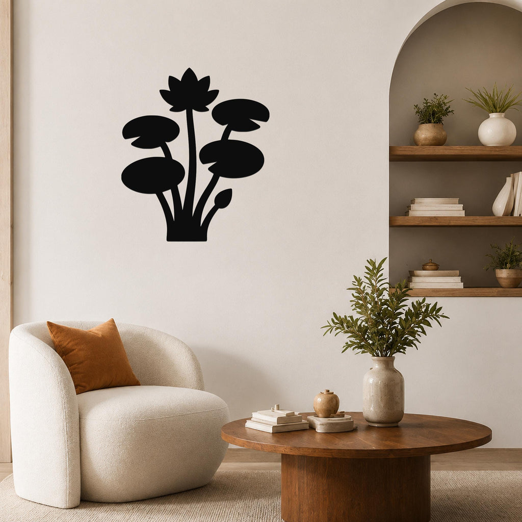 Black metal lotus and water lily wall art silhouette mounted on a living room wall above a round wooden coffee table.