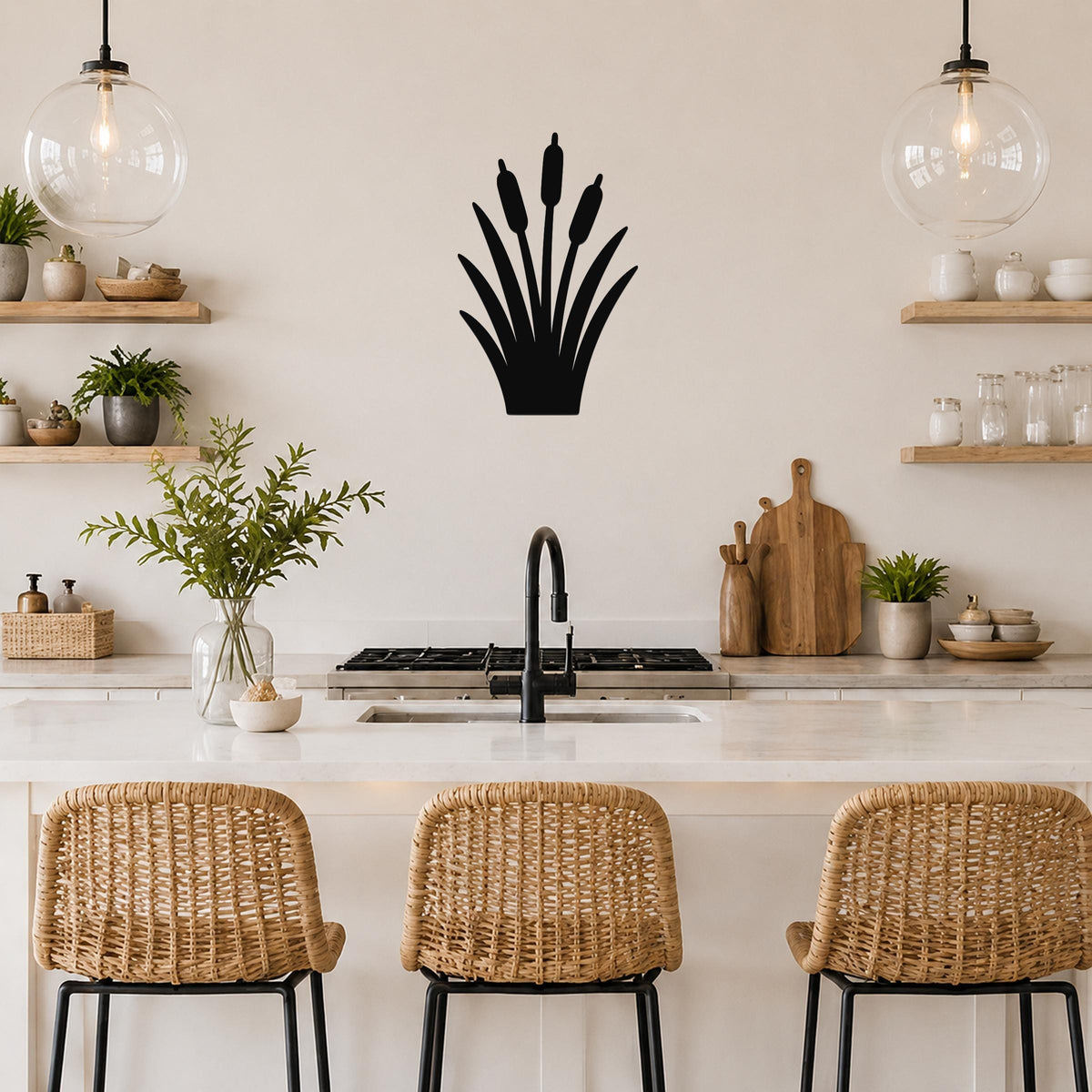 Black metal cattail wall art silhouette with tall reeds and seed heads, mounted on a kitchen wall above a counter.