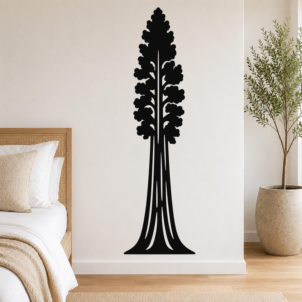 Black metal wall art of a sequoia tree silhouette with layered branches and a wide base, mounted on a bedroom wall above a bed.