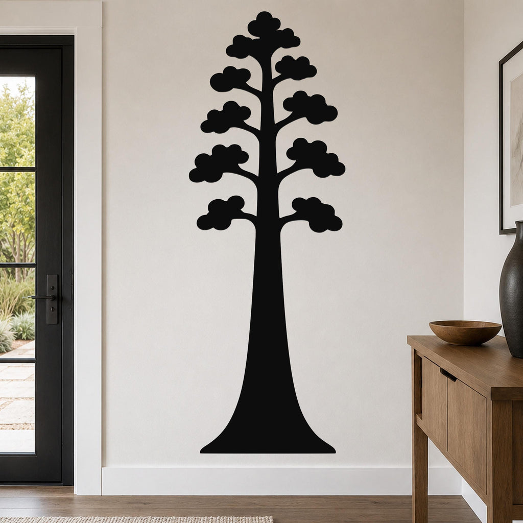 Black metal wall art in the silhouette of a sequoia tree with layered canopy cutouts, mounted on a living room wall above a wooden console table.