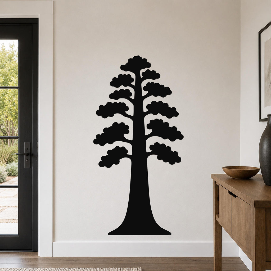 Black metal sequoia tree wall art with layered branch cutouts, mounted on a living room wall above a wooden console table.