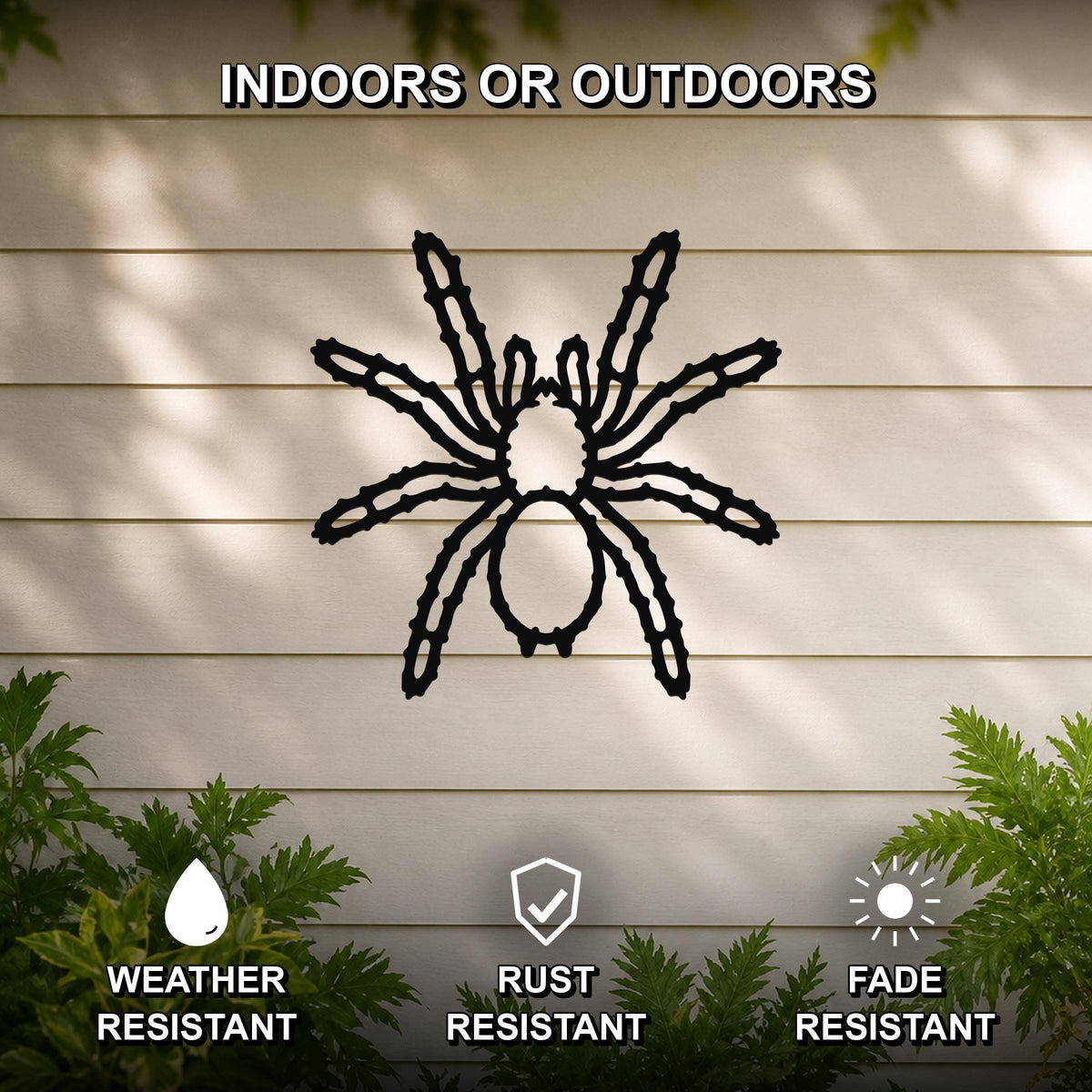 Black metal spider wall art with detailed leg cutouts, mounted on a beige outdoor wall with greenery, weather, rust, and fade resistant.