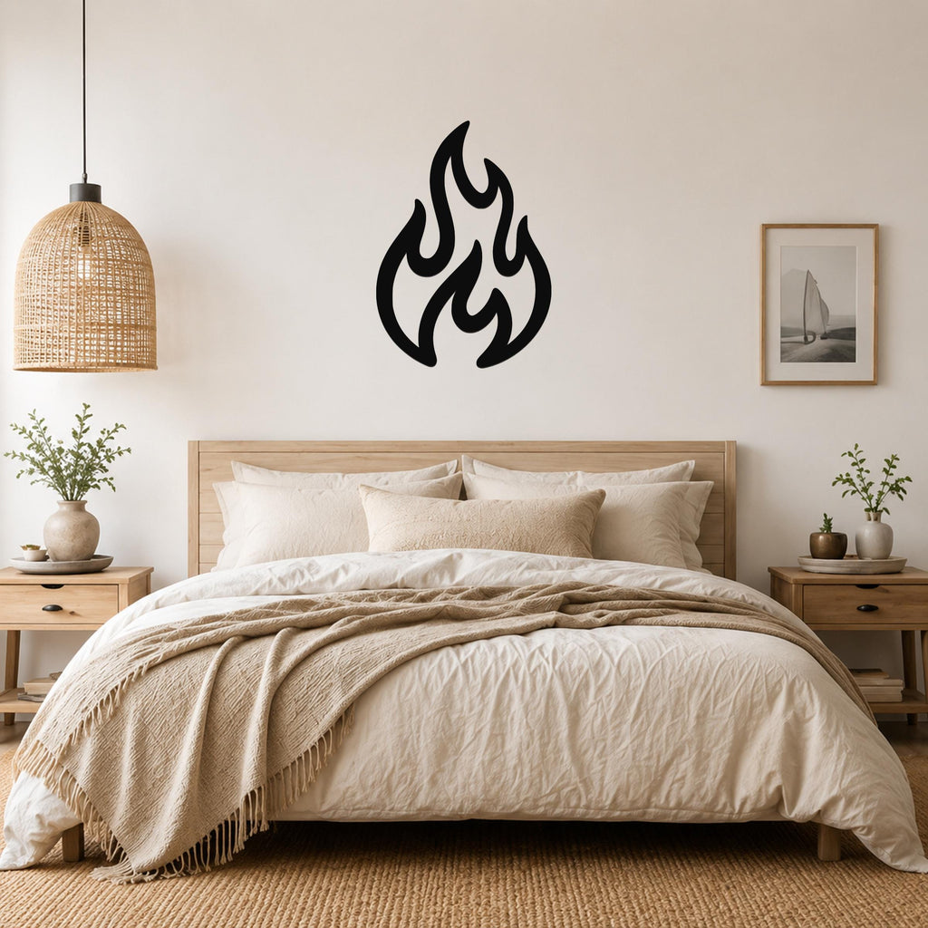 Black metal flame wall art with flowing cutout shapes, mounted above a wooden bed in a neutral bedroom.