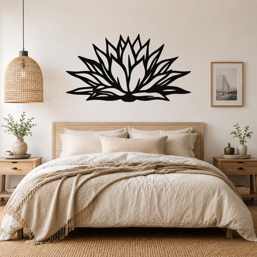 Black metal agave wall art with bold geometric cutouts, mounted above a bed in a neutral bedroom.