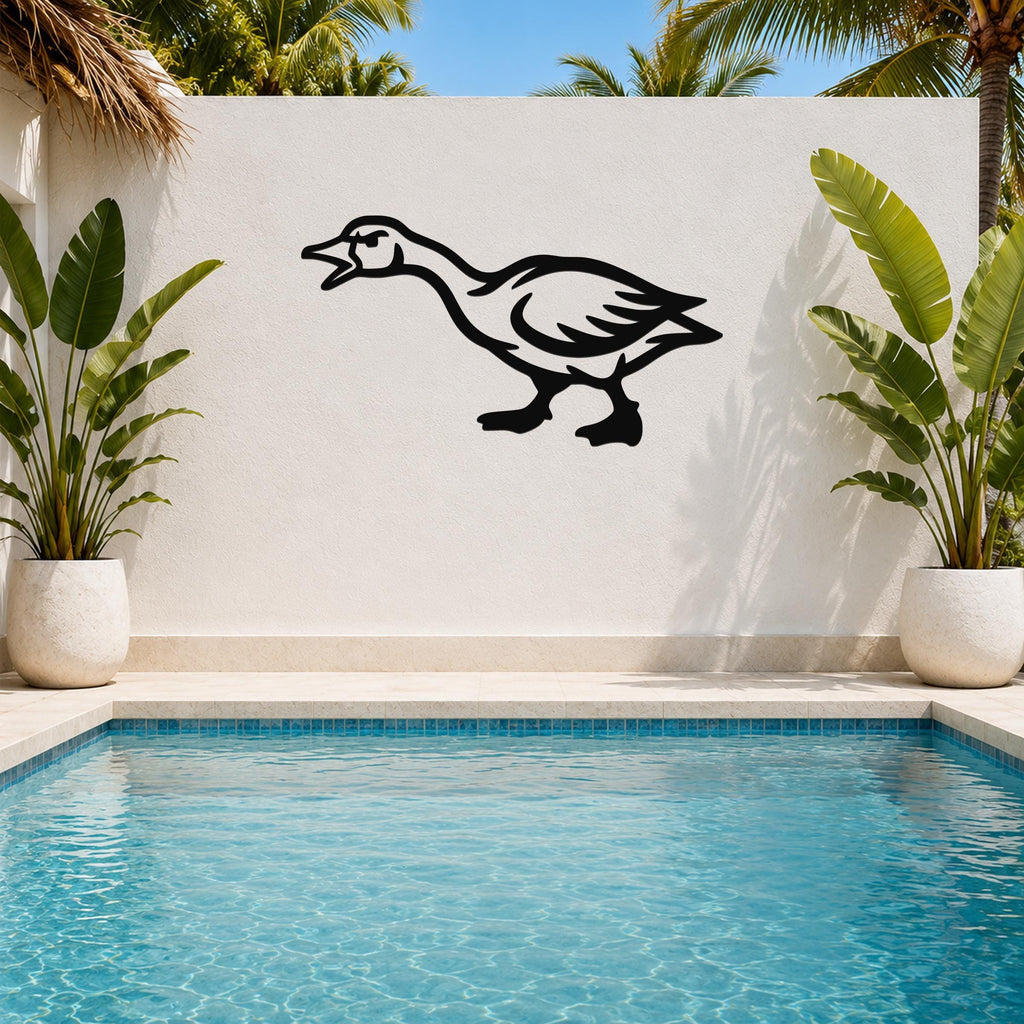 Black metal goose wall art with a silhouette design, mounted on a white outdoor wall above a pool, flanked by potted plants.