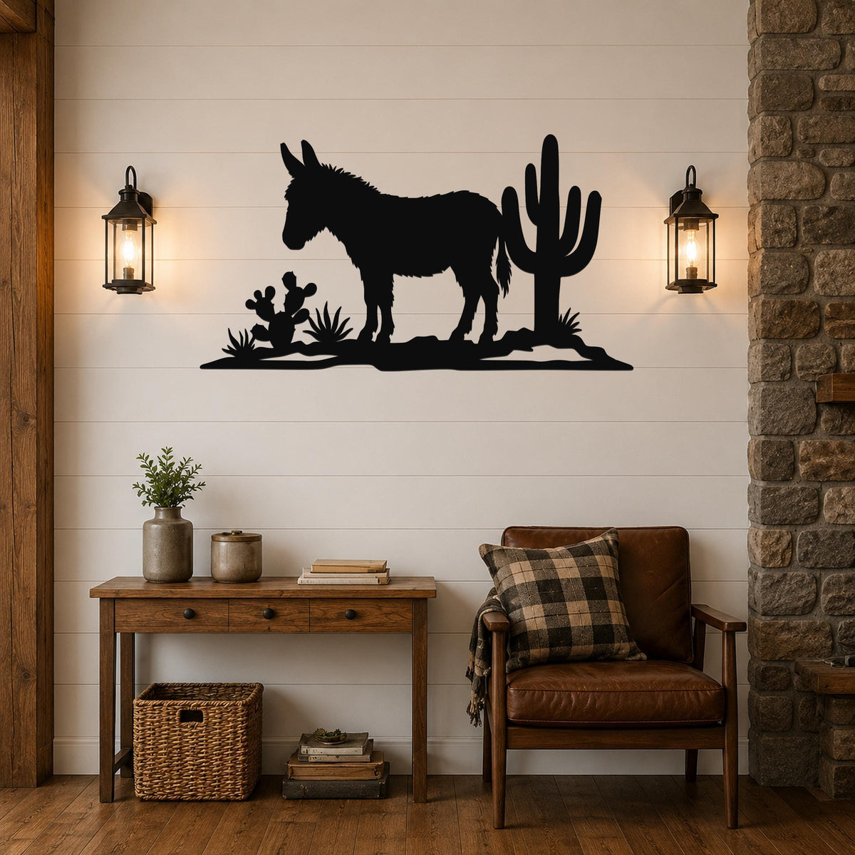Black metal wall art silhouette of a burro and cacti, mounted on a shiplap wall above a wooden console table in a living room.