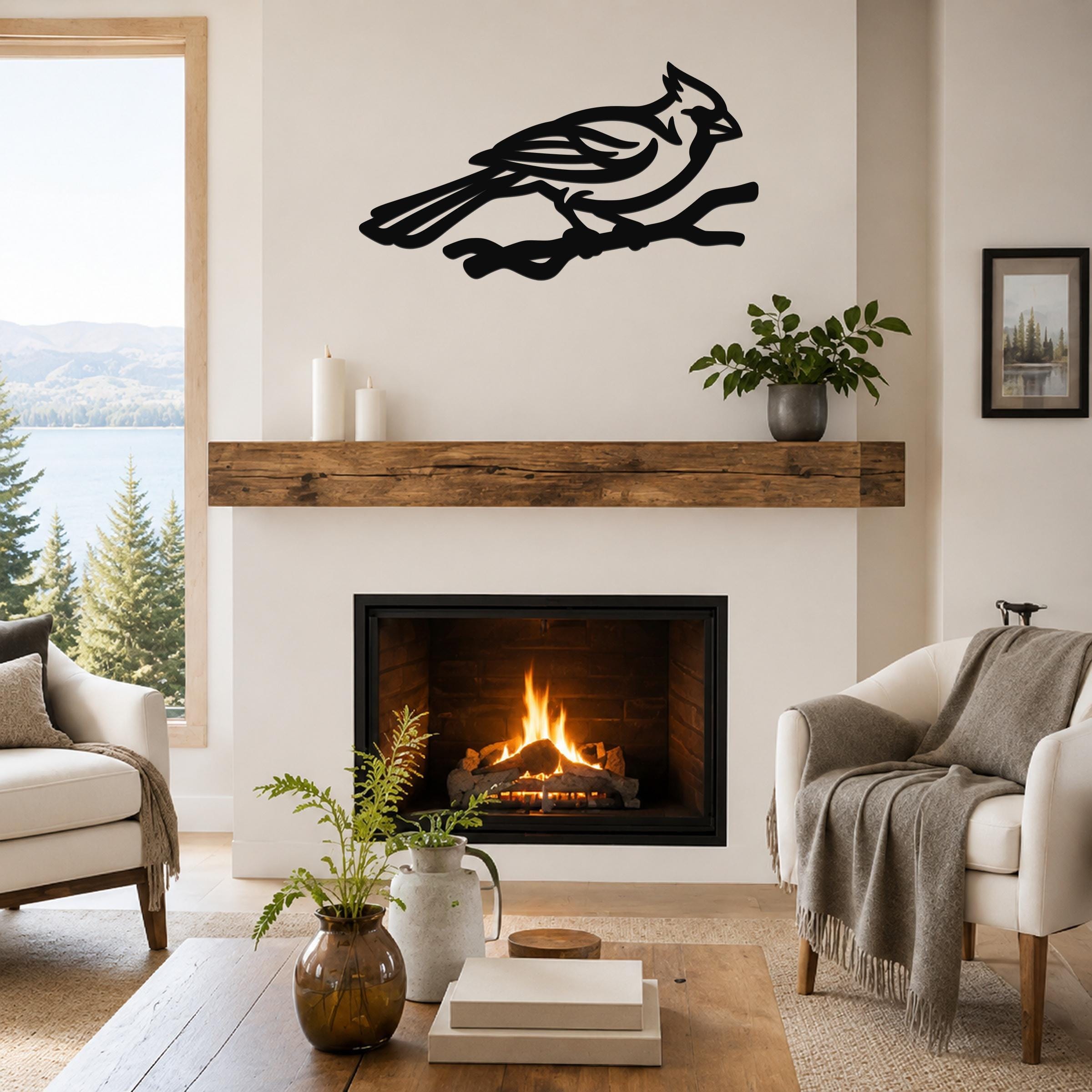 Black metal cardinal wall art in a bold silhouette cutout, mounted above a fireplace in a living room.