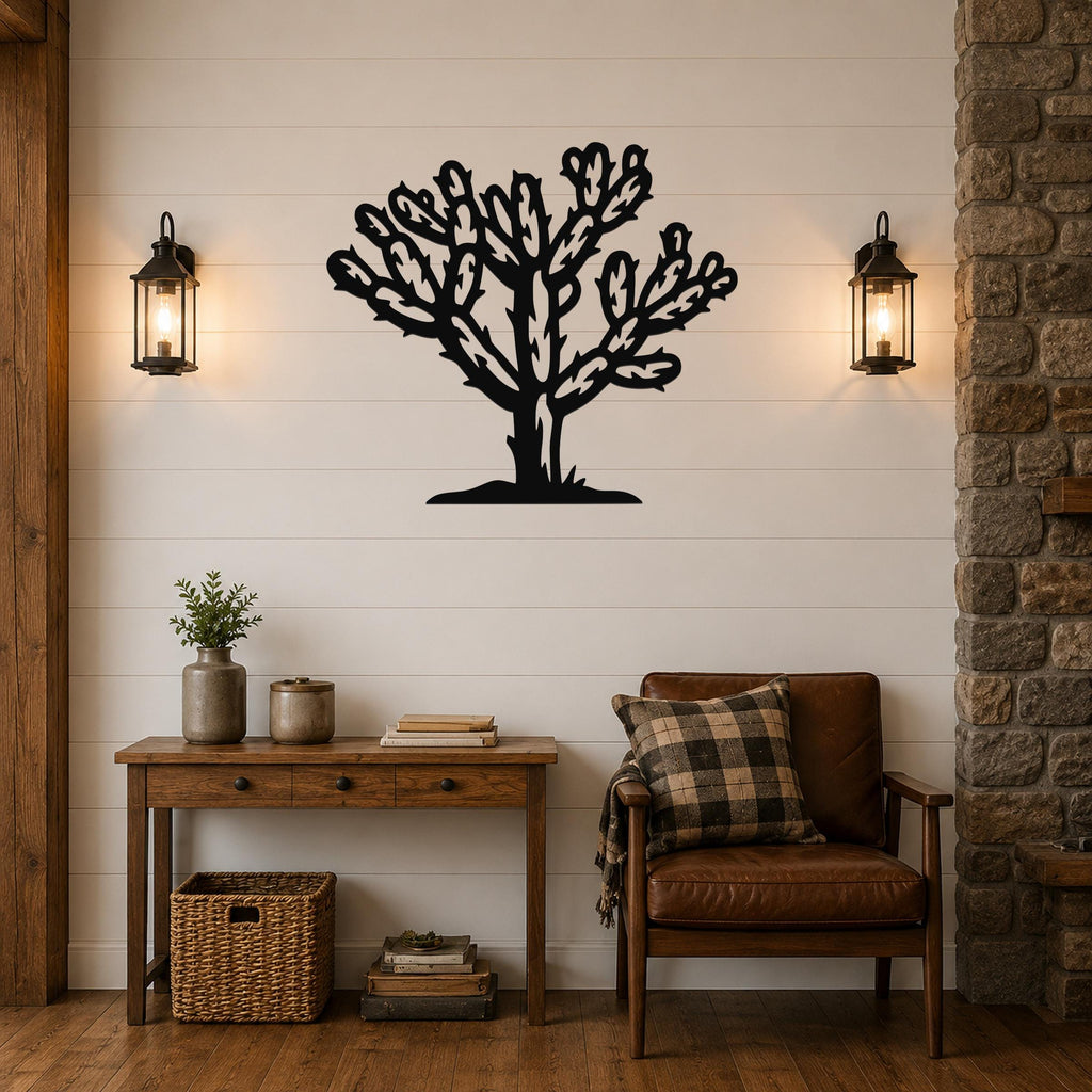 Black metal Cholla cactus wall art with intricate branch cutouts, mounted on a white shiplap wall above a wooden console table in a living room.
