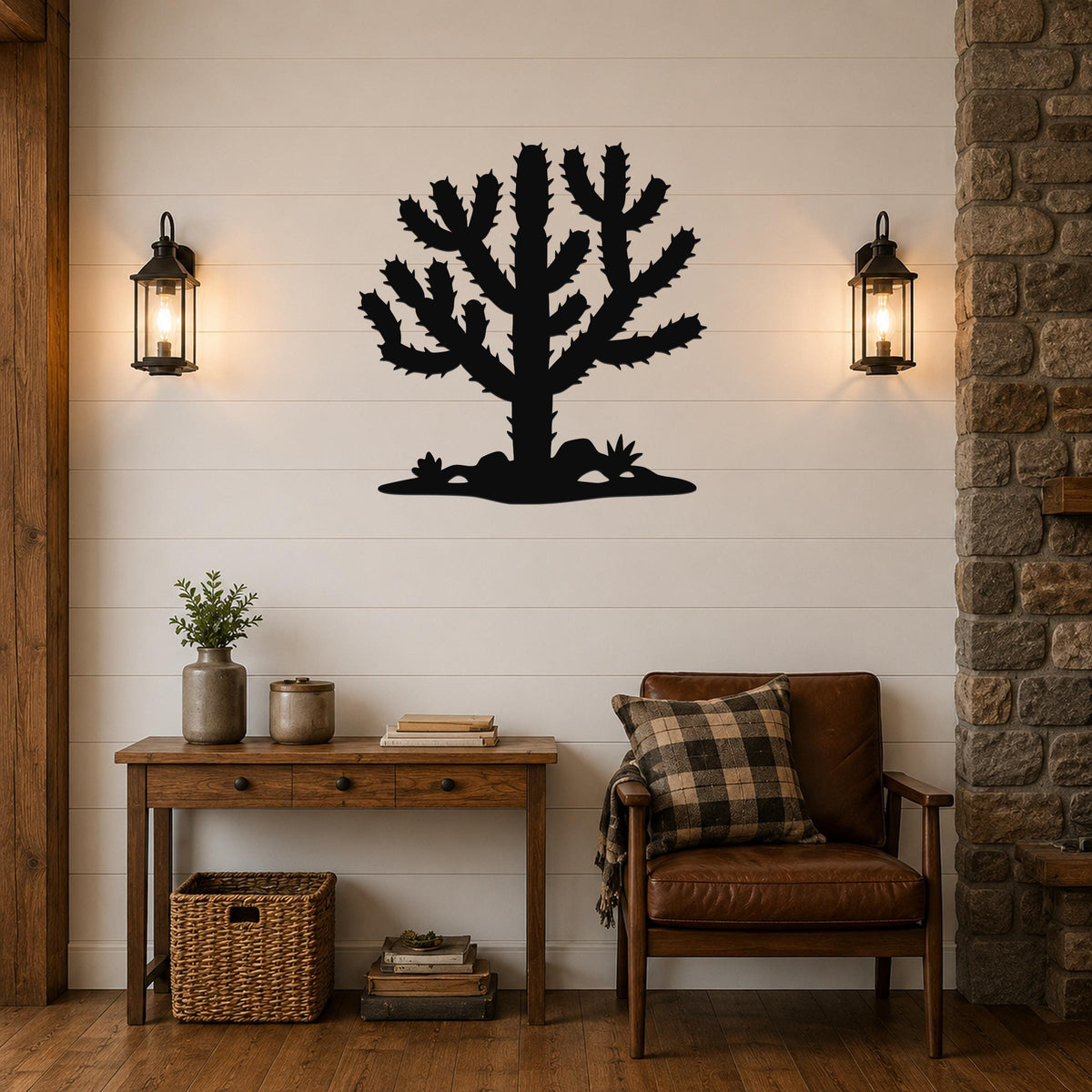 Black metal Cholla cactus wall art silhouette with spiny branches and base, mounted on a white shiplap wall above a wooden console table in a living room.