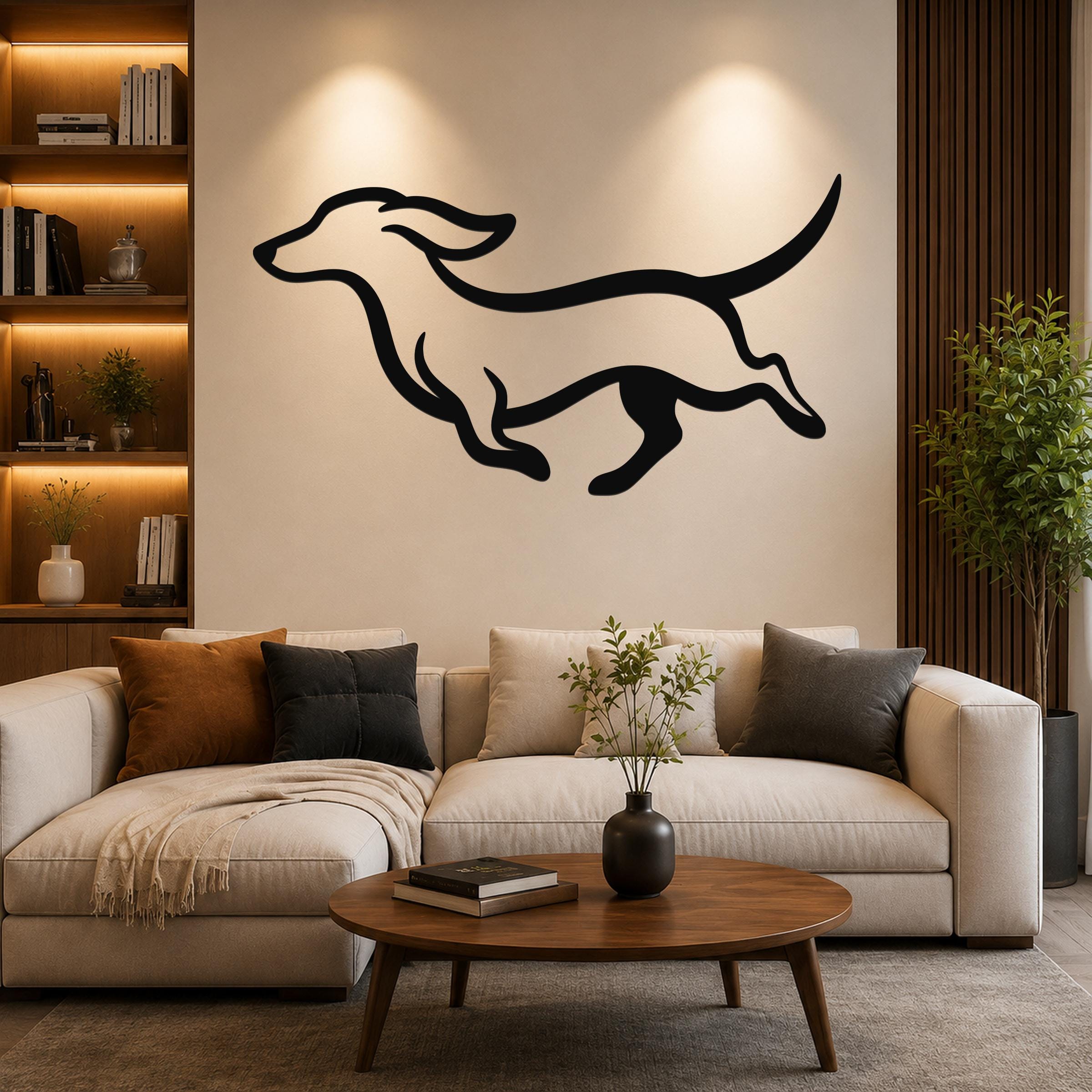 Black metal wall art in the silhouette of a running dachshund, mounted above a beige sofa in a living room.