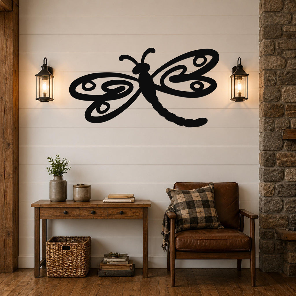 Black metal dragonfly wall art with swirling wing cutouts, mounted on a shiplap wall above a wooden console table in a living room.