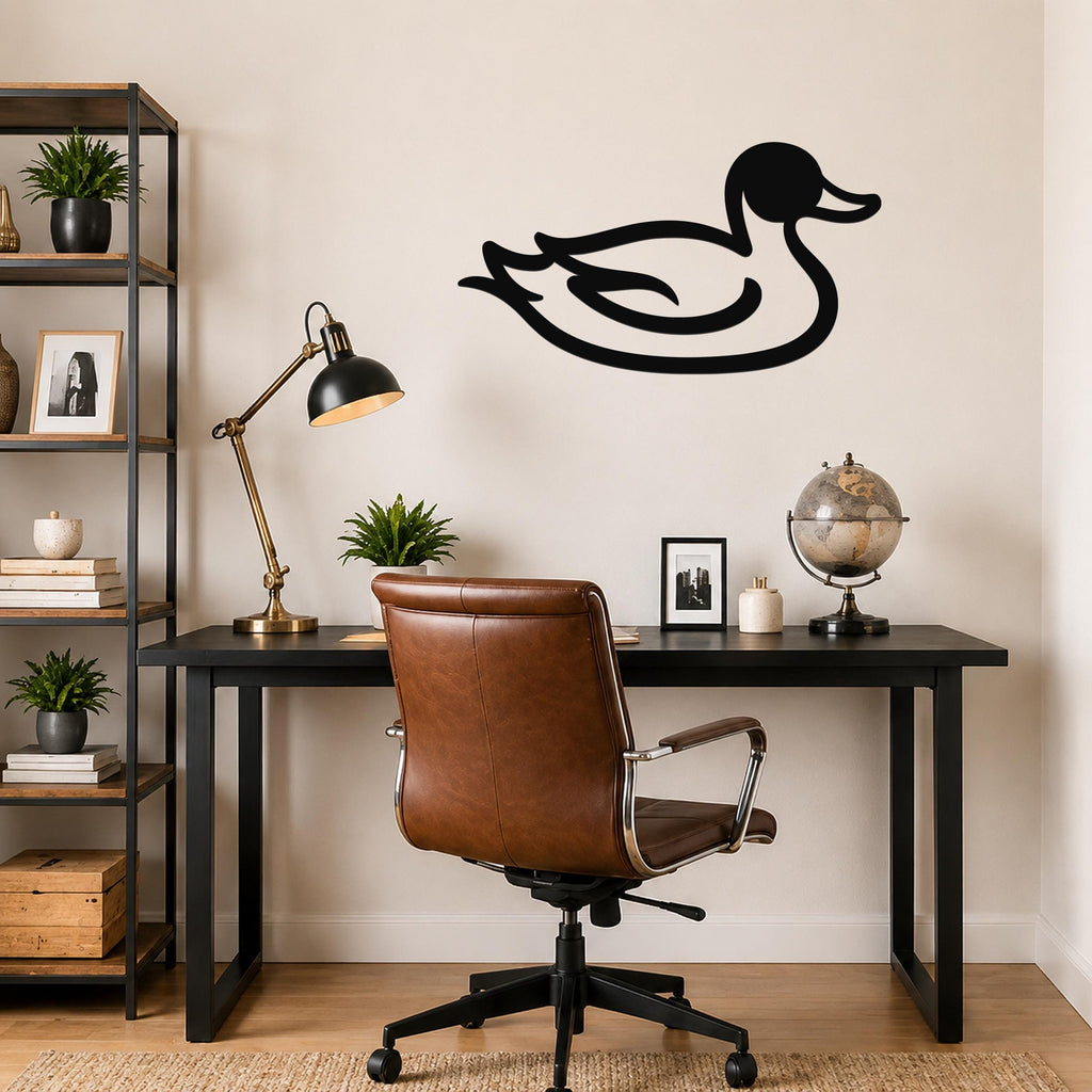 Black metal duck wall art silhouette mounted on a beige wall above a black desk in a home office.