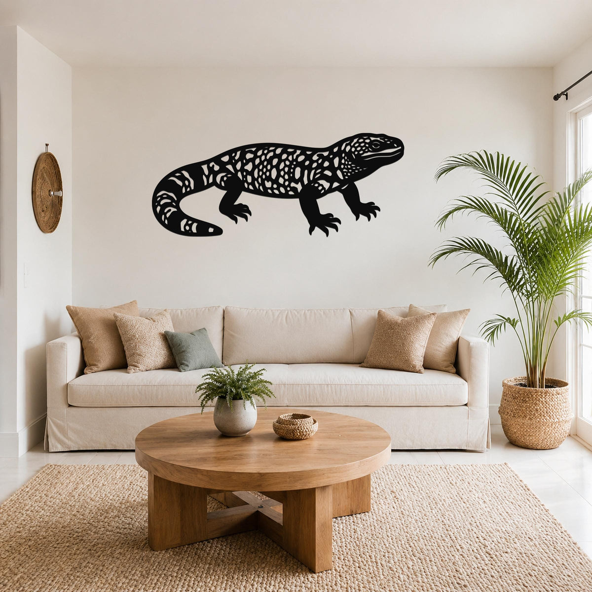 Black metal Gila monster wall art with intricate cutout patterns, mounted above a beige sofa in a living room.