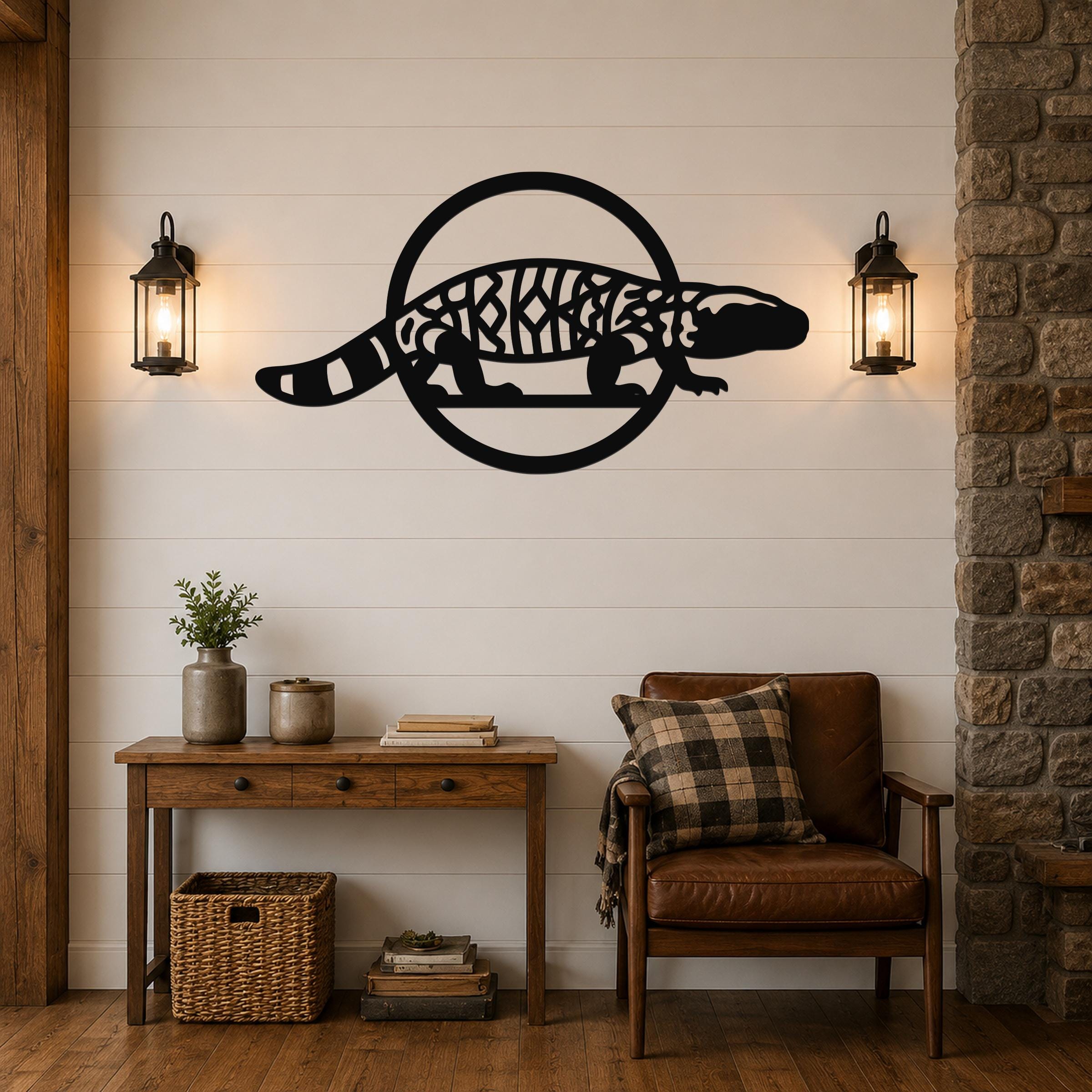 Black metal Gila monster wall art with intricate internal cutouts, mounted on a white shiplap wall above a wooden console table in a living room.