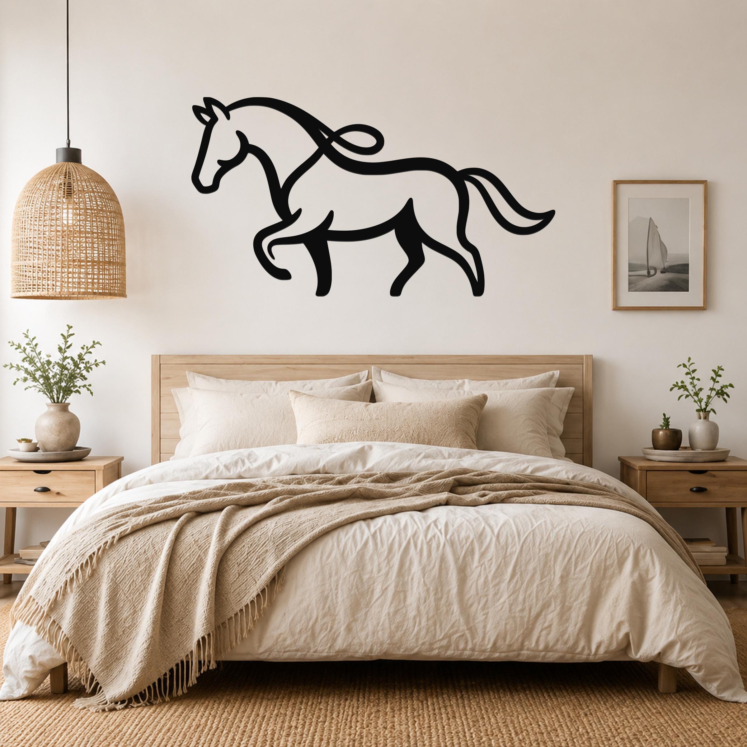 Black metal horse wall art with flowing mane and tail silhouette, mounted above a bed in a neutral bedroom.